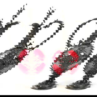 Pair Pedestal Decanters, Cranberry Art Glass Body: Pair Pedestal Decanters, Cranberry Art Glass Body, 15.5" x 7.5", Elaborate Embossed Silverplate Fittings, Full Figure Putti Stoppers, Nice Pair, These Items Sold In A Previous Woody Auction But Buyer