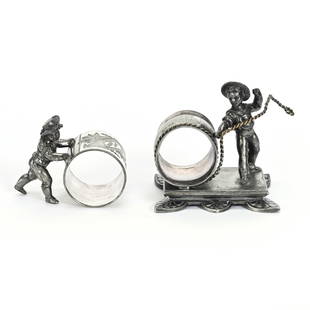 (2) Figural Napkin Rings, Silverplate: (2) Figural Napkin Rings, Silverplate, (1) Marked Reed & Barton #1346, Boy Roping Barrel, Rope Is Not Currently Attached To His Hand, (1) Marked Meriden #161, Boy Pushing Ring, Alabama Private Collect