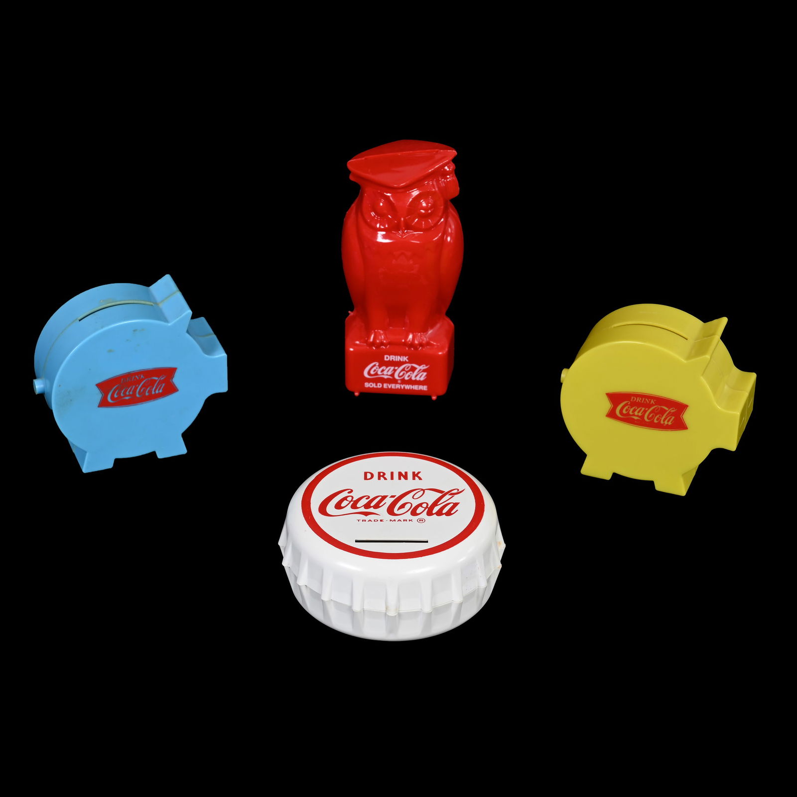 Coca Cola Plastic Banks: Coca Cola Plastic Banks, (1) Red Owl, (1) White Bottle Cap, (1) Blue Pig, (1) Green Pig, Kansas Private Collection.