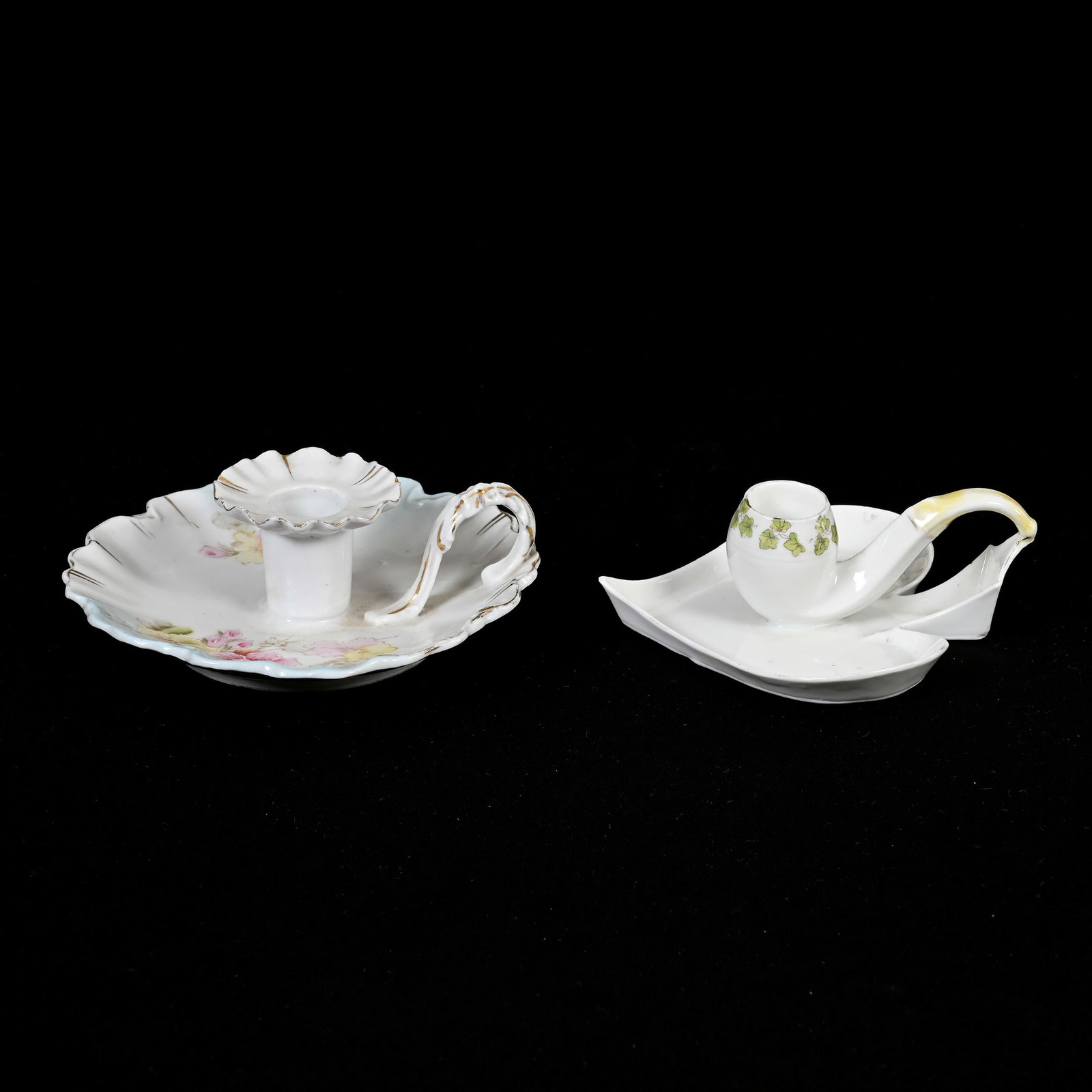 (2) Chambersticks, Unmarked R.S. Prussia: (2) Chambersticks, Unmarked R.S. Prussia, (1) 5.5", Blue And White, Floral Decor, Underside Rim Chip, (1) 4.75", Spade-Shaped With Figural Pipe Handle, Lee & Carol Marple Collection.