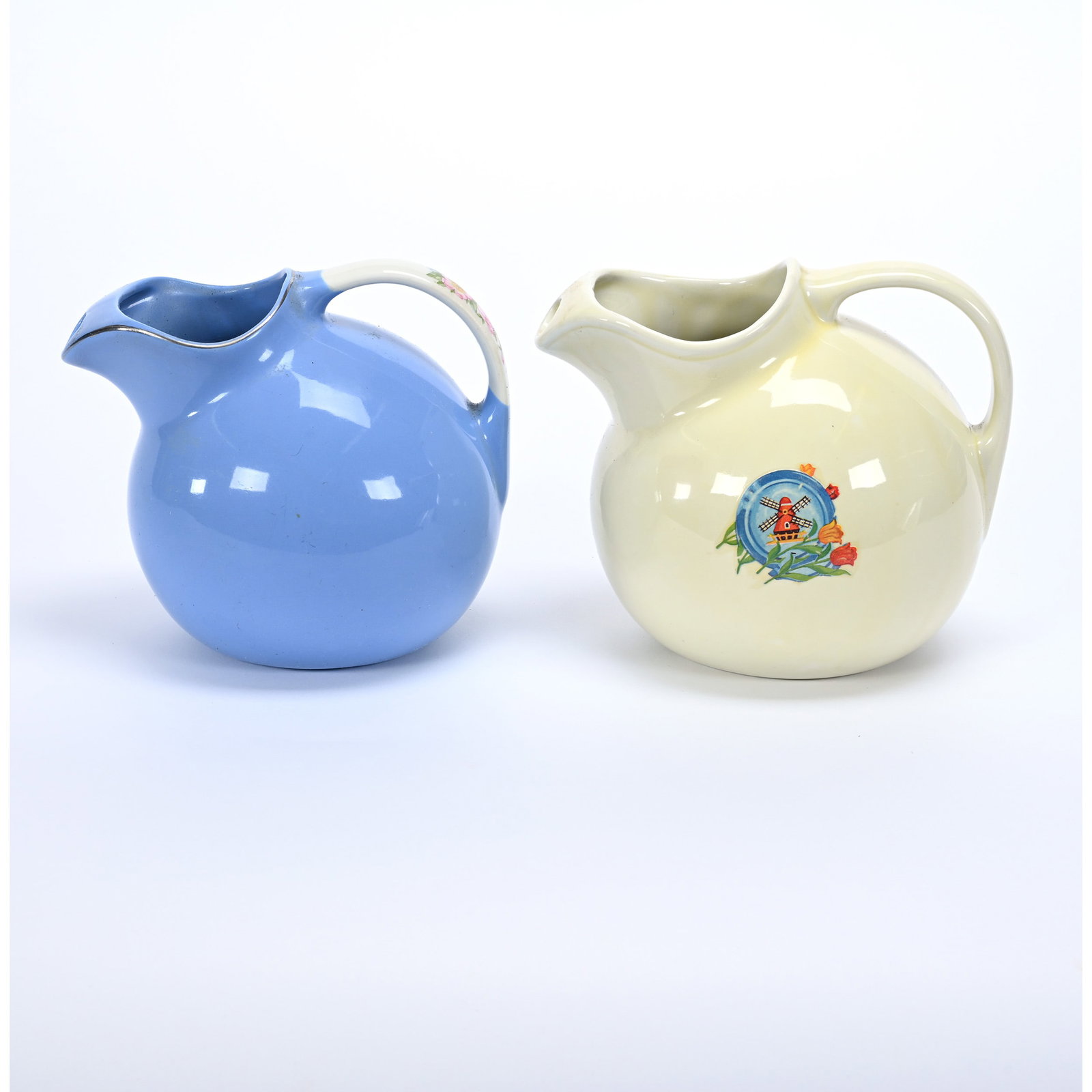 (2) Ball Pitchers By Hall Pottery, Model #633: (2) Ball Pitchers By Hall Pottery, Model #633, 7" x 8" Approximately, Blue With Decorated Floral Handle Called "Rose Parade", One White With Dutch Mill And Tulip Possibly Added Later, Collection Of Fr
