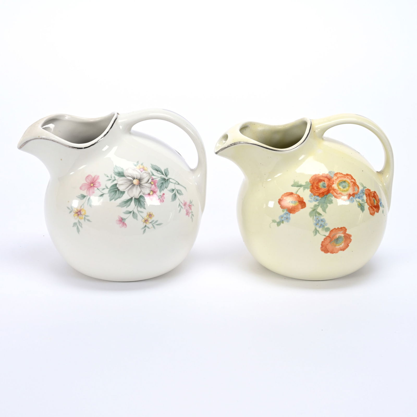 (2) Ball Pitchers Marked Hall Pottery #633: (2) Ball Pitchers Marked Hall Pottery #633, 7" x 8", (1) White With Floral Decor Called "Springtime", (1) Cream With Floral Decor Called "Orange Poppy", Collection Of Frank & Melissa Keathley, Top She