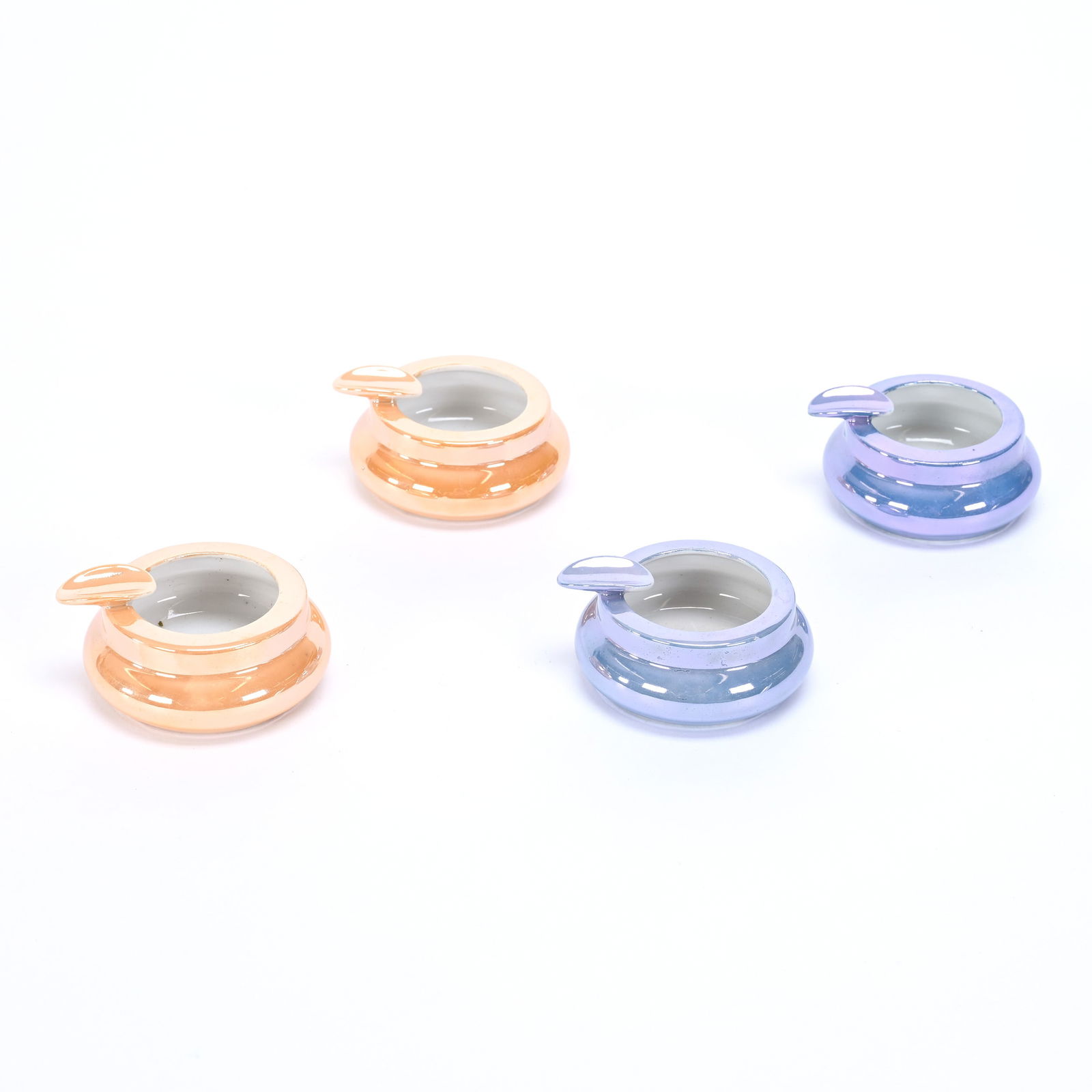 (4) Individual Ashtrays Marked Noritake: (4) Individual Ashtrays Marked Noritake, Approximately 2.5", In Original Box, Two Are Orange Luster, Two Are Blue Luster, Texas Private Collection.