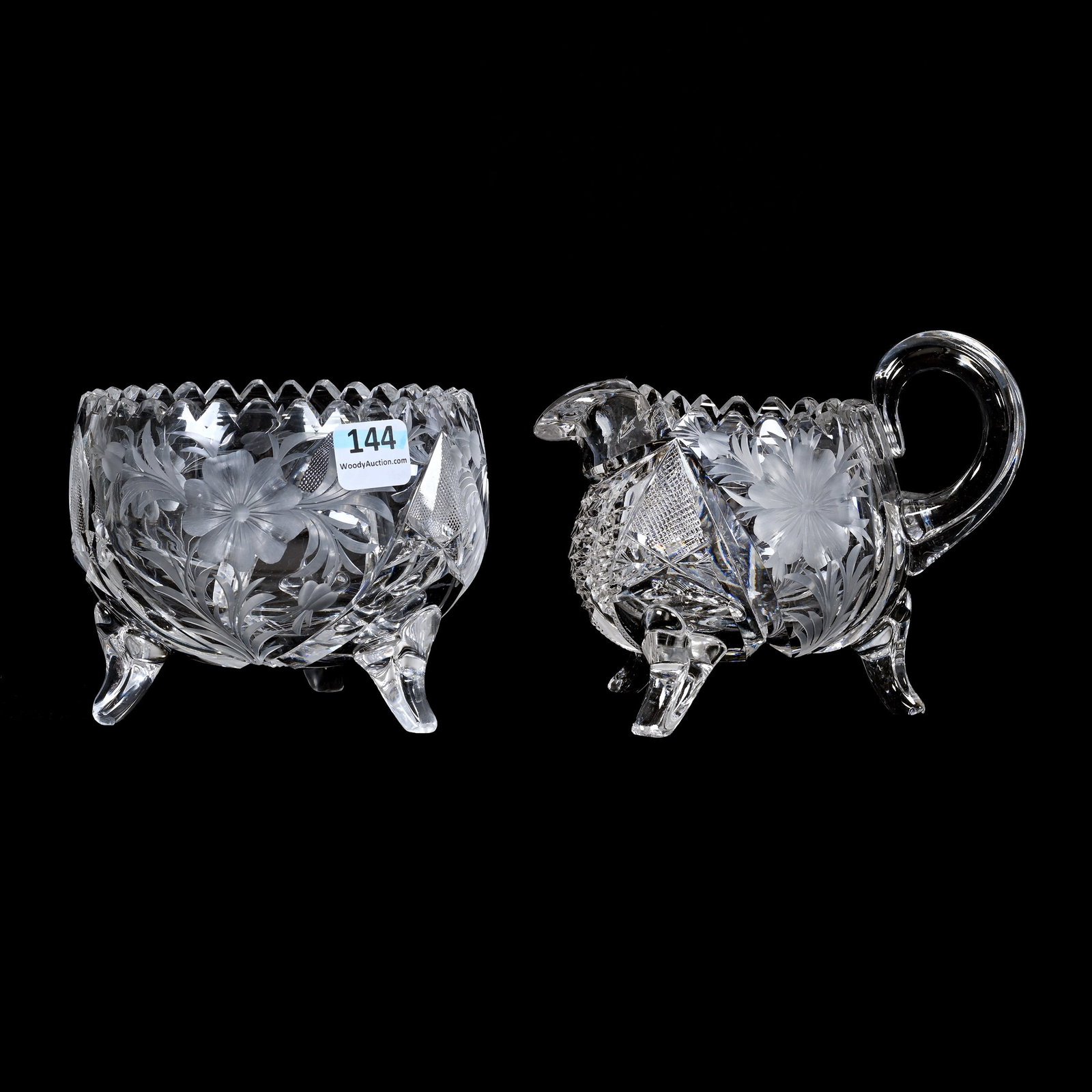 Creamer & Sugar Set, ABCG, Three Feet: Creamer & Sugar Set, American Brilliant Cut Glass, Three Feet, 4.25" x 5.5", Three Sections Of Engraved Cosmos Decor, Applied Ribbed Handle, Creamer With Nick On Foot, Estate Of Jean & Ralph Borelli.