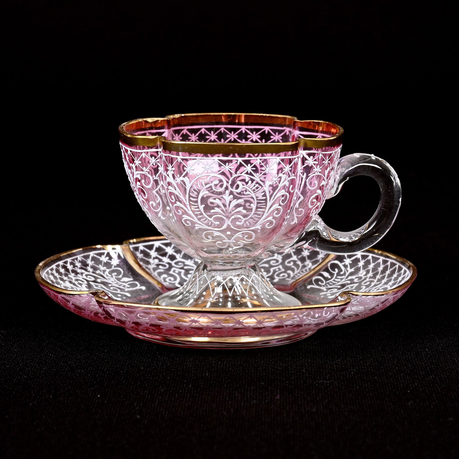 Cup & Saucer, Pink Shading To Clear Art Glass: Cup And Saucer, Pink Shading To Clear, 2.5" x 4.75", White Enamel Lace And Scroll Design, Gold Stencil Highlights, Missouri Private Collection.