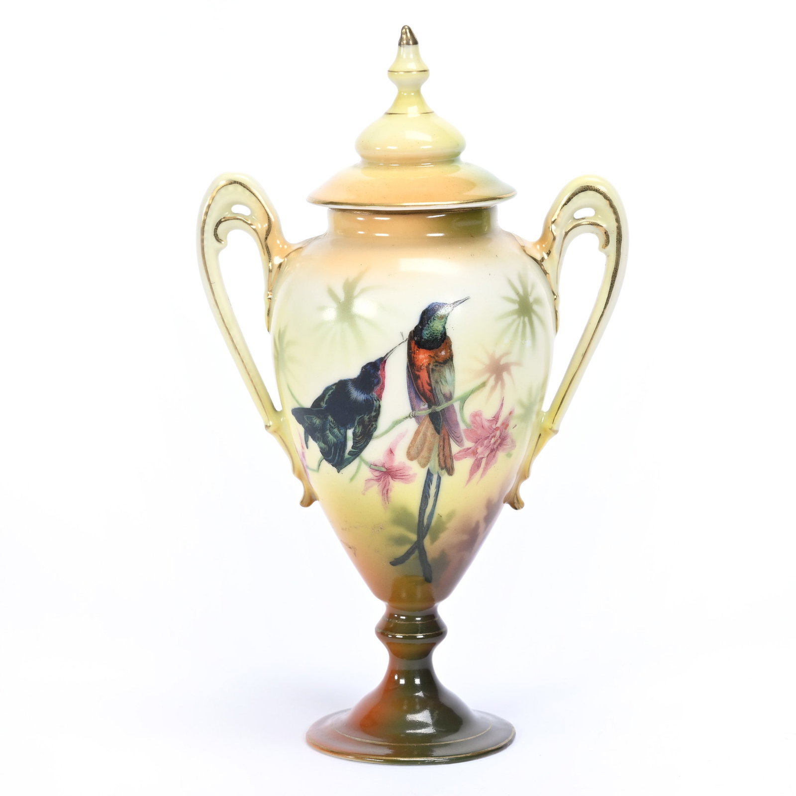 Covered Pedestal Urn, Unmarked Royal Bayreuth: Covered Pedestal Urn, Unmarked Royal Bayreuth, 8" x 4.75", Brown, Yellow And Green Tones, Hummingbird And Parrot Decor, Hairline In One Handle, Tennessee Private Collection. UPDATED 5/28/24: See Addit