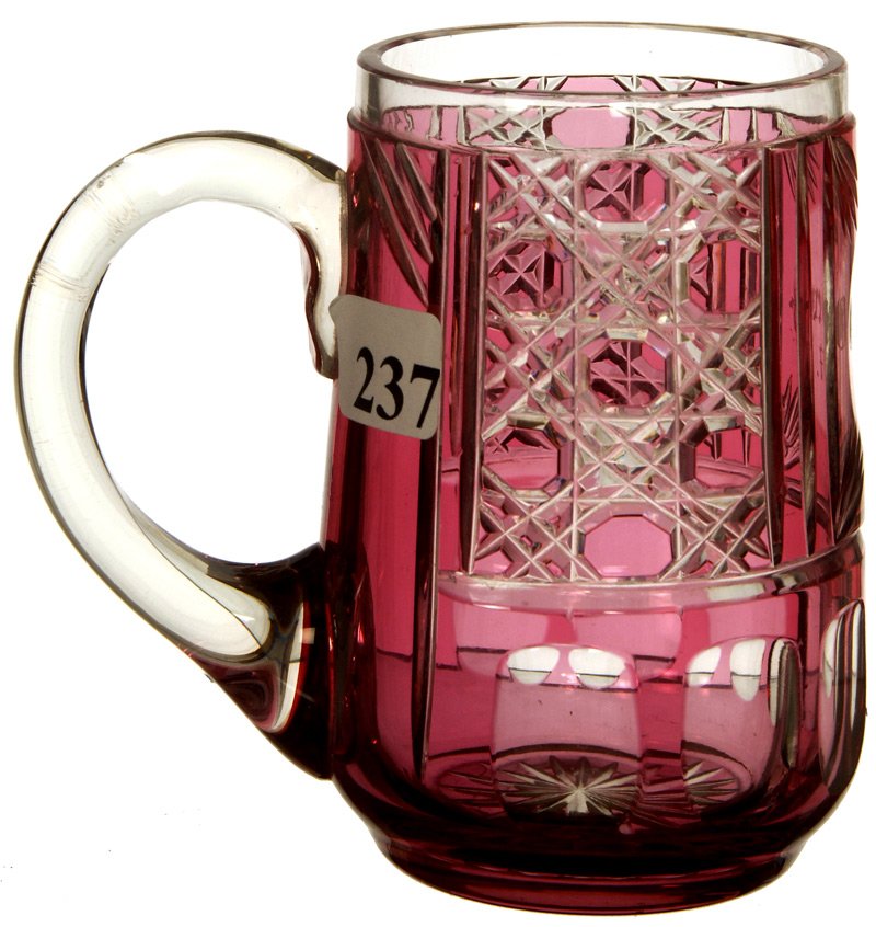 4 1/4" ENGLISH CRANBERRY CUT TO CLEAR MUG: 4 1/4" ENGLISH CRANBERRY CUT TO CLEAR MUG CANE PATTERN WITH MEDALLION ENGRAVED "OTTO WENGEL 1897"
