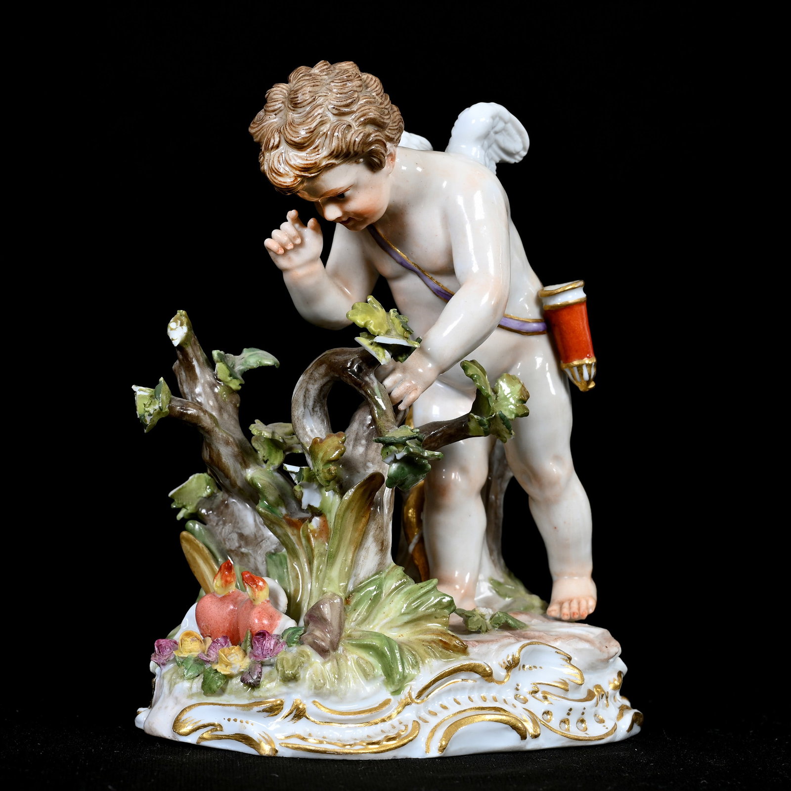 Figurine Marked Meissen #O187(Blue Crossed Swords): Figurine Marked Meissen #O187(Blue Crossed Swords), 4.5" x 3.5", Titled "Cherub Looking For Blazing Hearts", Several Leaf Chips. This Item Was Sold In A Previous Woody Auction, However Buyer Did Not C