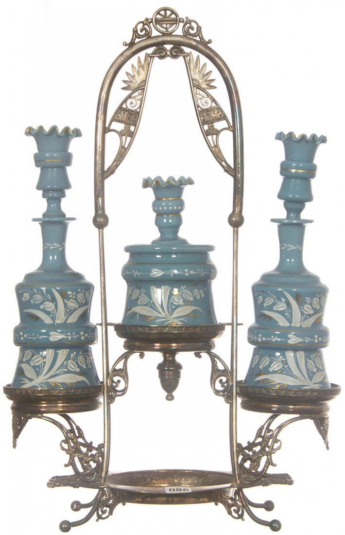 RARE 18" X 11 1/2" THREE PIECE VICTORIAN DRESSER SE: RARE 18" X 11 1/2" THREE PIECE VICTORIAN DRESSER SET (3) BLUE BRISTOL ART GLASS BOTTLES WITH WHITE ENAMEL FLORAL DECOR - (2) PERFUMES ARE 9 1/2" HT. - (1) COVERED BOX IS 6" HT. - ALL SET ON ORNATE PAI