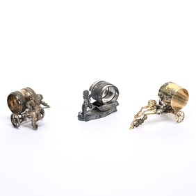 (3) Figural Napkin Rings, Cherubs Pulling Carts