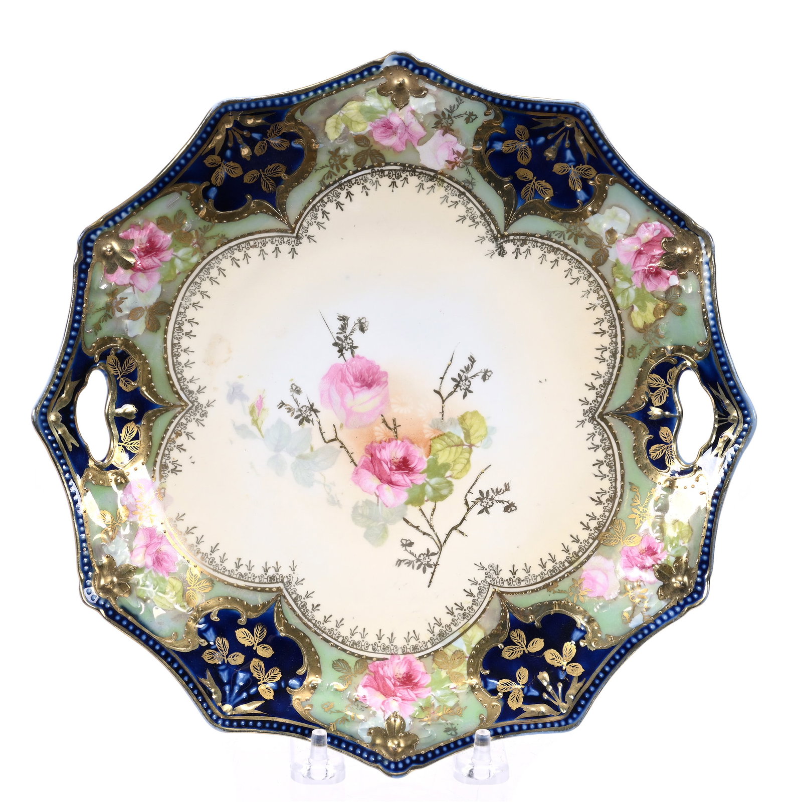 Cake Plate Marked R. S. Prussia: Cake Plate Marked R. S. Prussia, 9.75", Swag And Tassel Mold, Cream Center, Pink Rose Decor, Green Luster And Cobalt Blue Border, Illinois Private Collection.