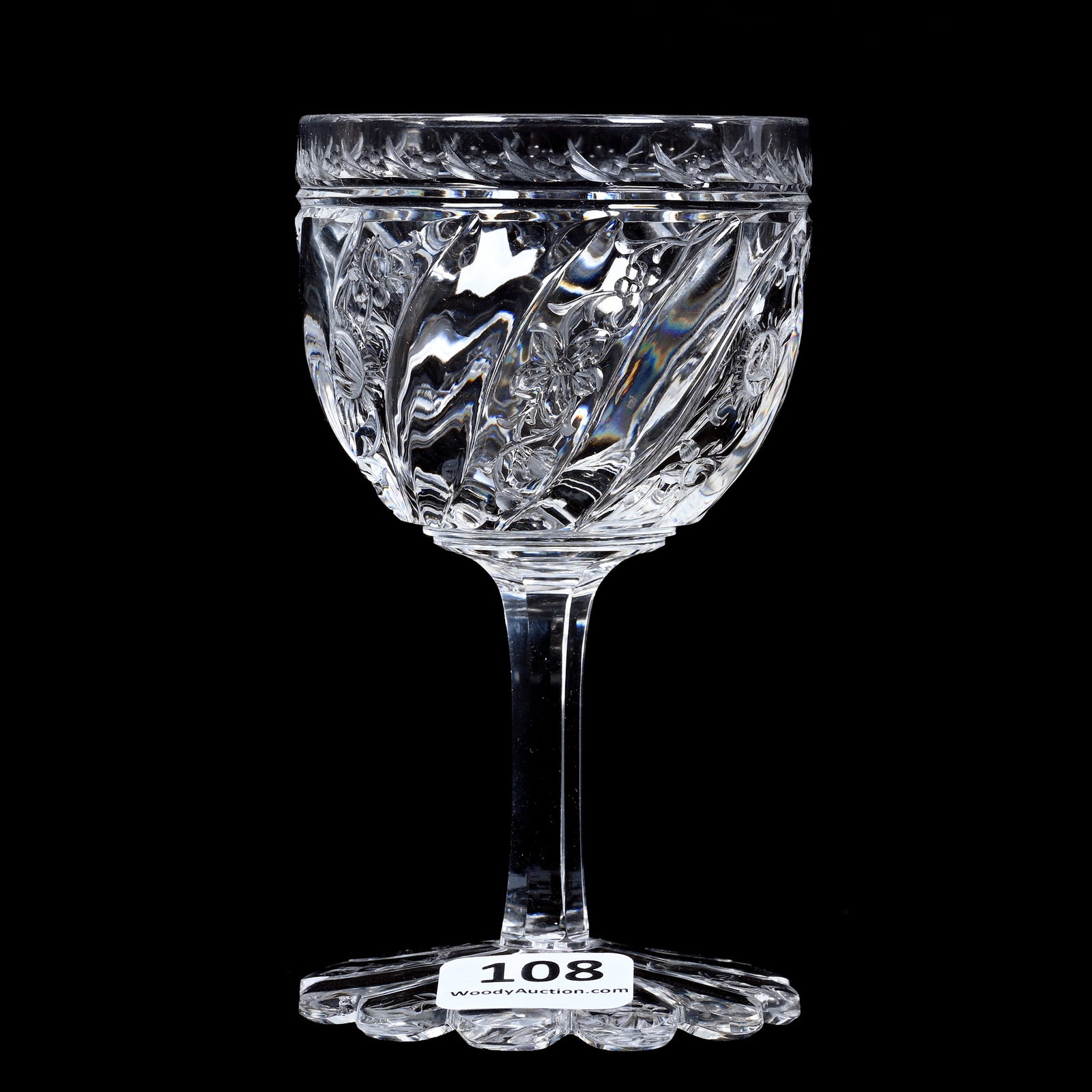 Wine Stem, Brilliant Period Cut Glass: Wine Stem, Brilliant Period Cut Glass, 4" x 2.25", Swirled Tusk With Alternating Engraved Floral Highlights, Scalloped Pattern Cut Foot, Pattern Matched To Lot #209, The Late Linda Guyer Collection.