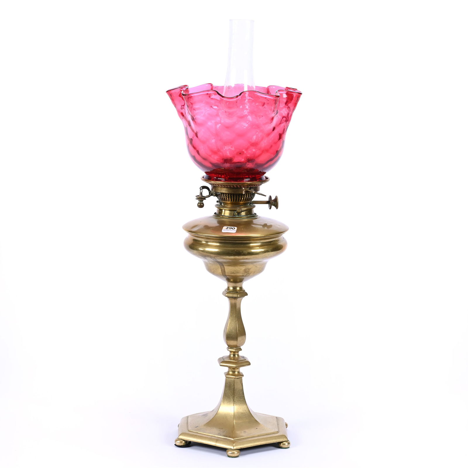 Banquet Lamp, Brass Kerosene Base With Cranberry Honeycomb Art Glass Shade: Banquet Lamp, Brass Kerosene Base With Cranberry Honeycomb Art Glass Shade, 23" x 8.5", Collection Of Gus D. Kokinos, Louisiana.
