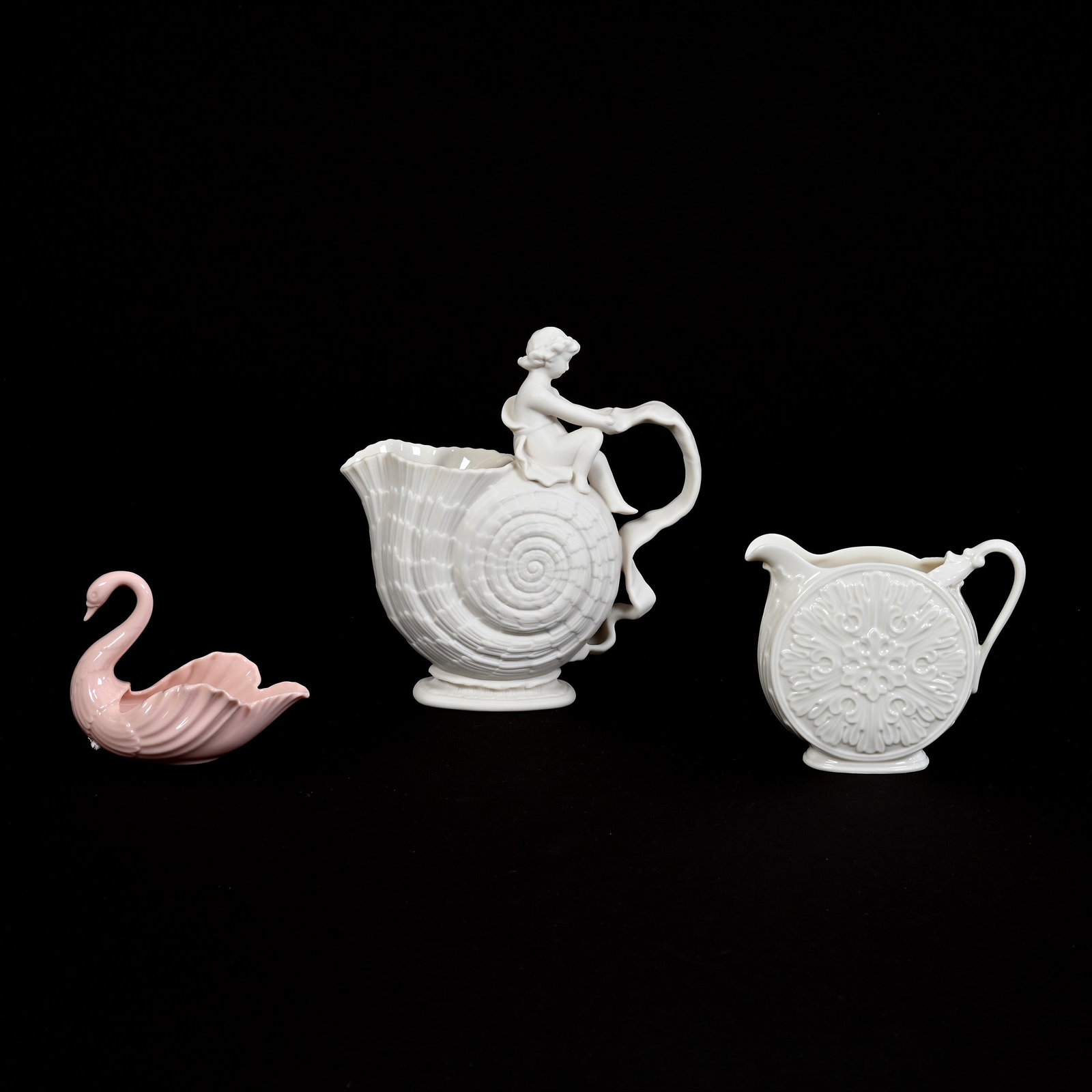 (3) Lenox Belleek Items: (3) Lenox Belleek Items, (1) 8" x 7.5" Nautilus Pitcher With Cherub, Limited Edition #3581, Centennial Reproduction Of Walter Scott Lenox Vase, (1) 4.5" x 5.5" Pitcher, (1) 3.75" x 4.75" Pink Swan Sal