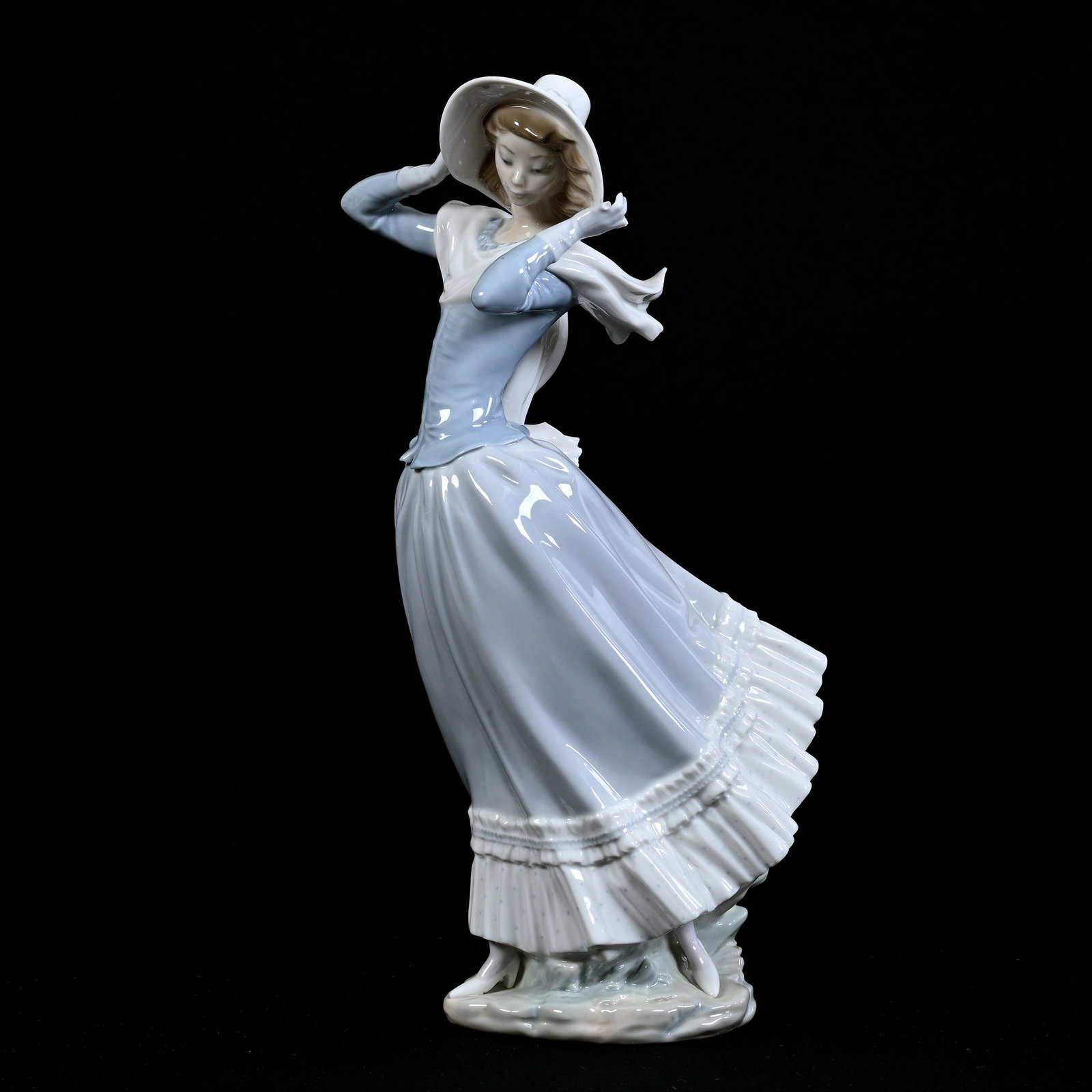 Figurine Marked Lladro #4936 Titled "Spring Breeze": Figurine Marked Lladro #4936 Titled "Spring Breeze", 13.75" x 6", Two Fingers Missing On Left Hand, Scarf Chipped, Estate Of Marvin And Elfriede MIller, North Dakota.