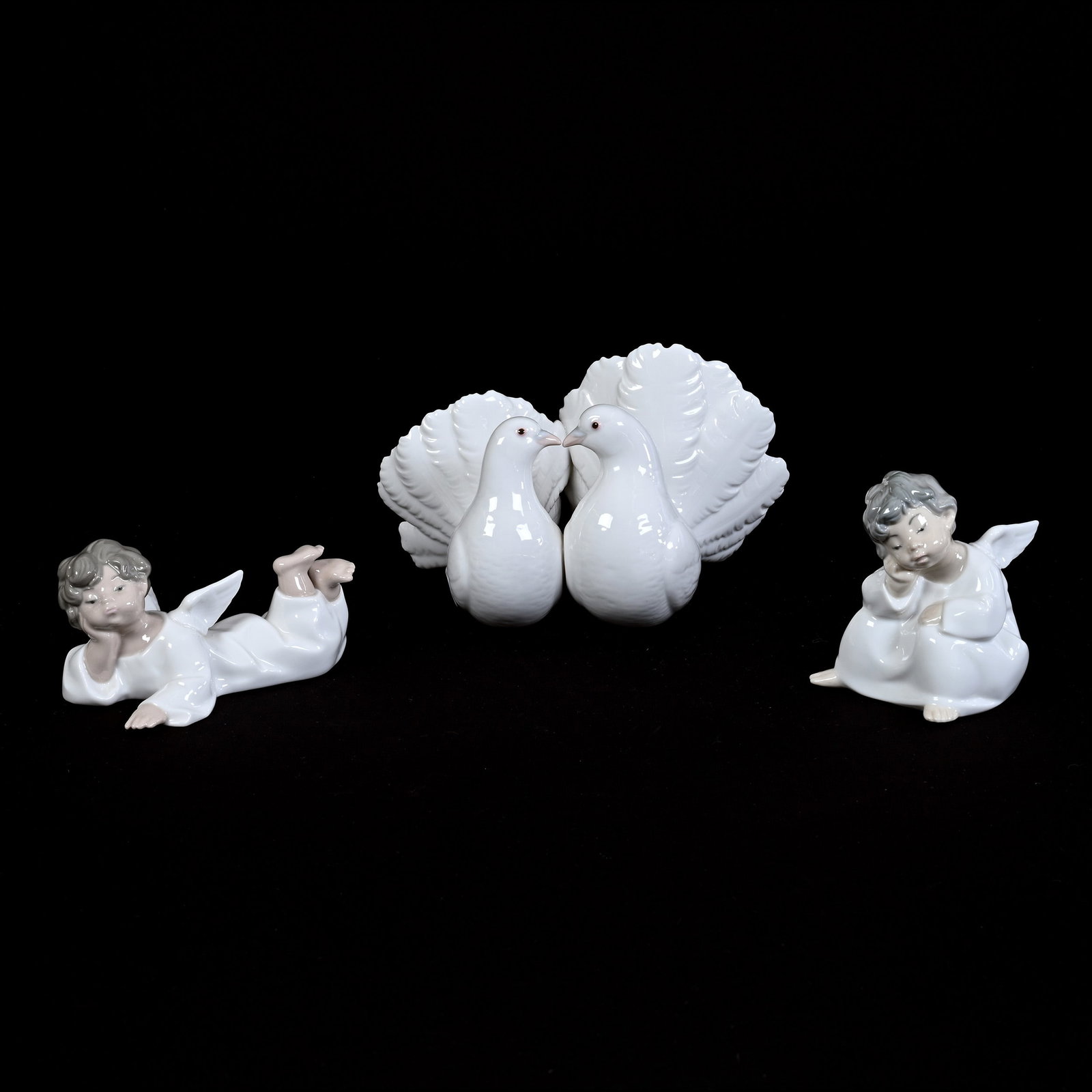 Lladro Figurines, (1) 5" x 8" Kissing Doves #1169, (1) 4" Cherub, (1) 2.75" Cherub: Lladro Figurines, (1) 5" x 8" Kissing Doves #1169, (1) 4" Cherub, (1) 2.75" Cherub, Estate Of Marvin And Elfriede MIller, North Dakota.