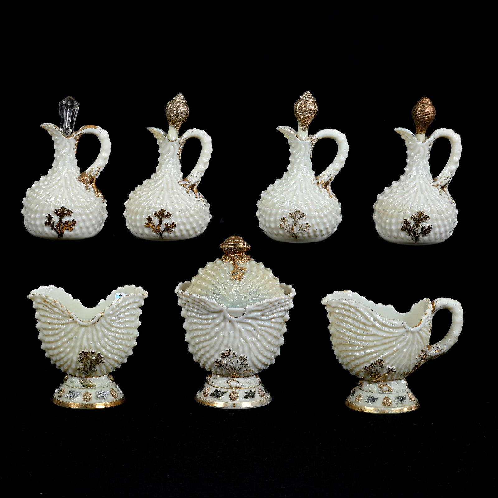 (7) Custard Glass Items In Argonaut Shell Pattern By Northwood: (7) Custard Glass Items In Argonaut Shell Pattern By Northwood, Includes (1) Covered Sugar, Finial Nicks, (1) Creamer, Foot And Rim Repair, (1) Spooner, (4) Cruet Bottles, One With Replacement Stopper