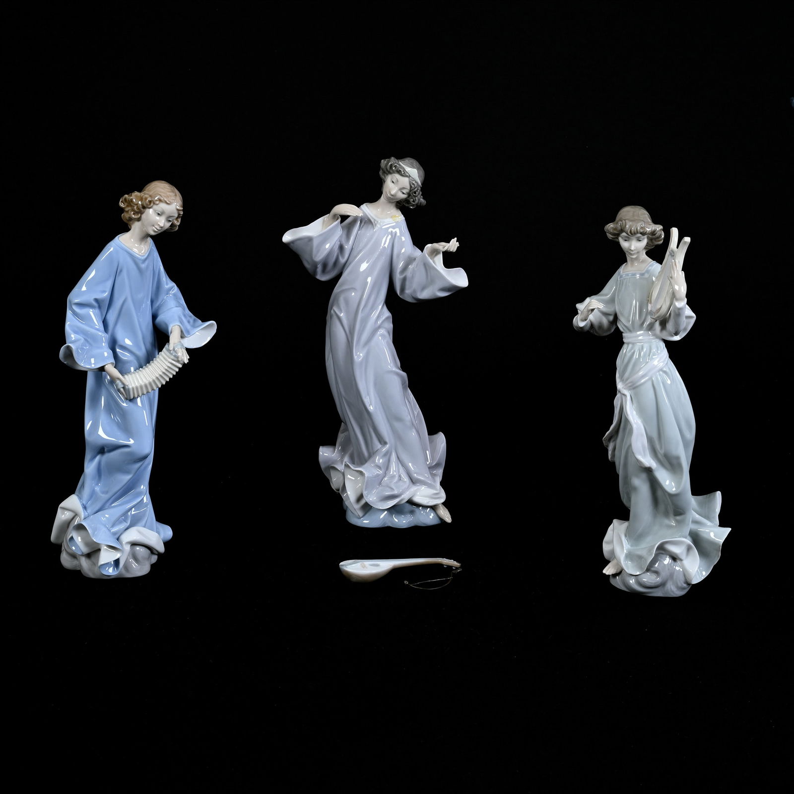 (3) Figurines Marked Lladro Titled "The Musicians": (3) Figurines Marked Lladro Titled "The Musicians", 12.5" approximately, One With Harp, One With Mandolin, One With Accordion, No Damage But Mandolin Adhesive Needs Reapplied, Estate Of Marvin And Elf