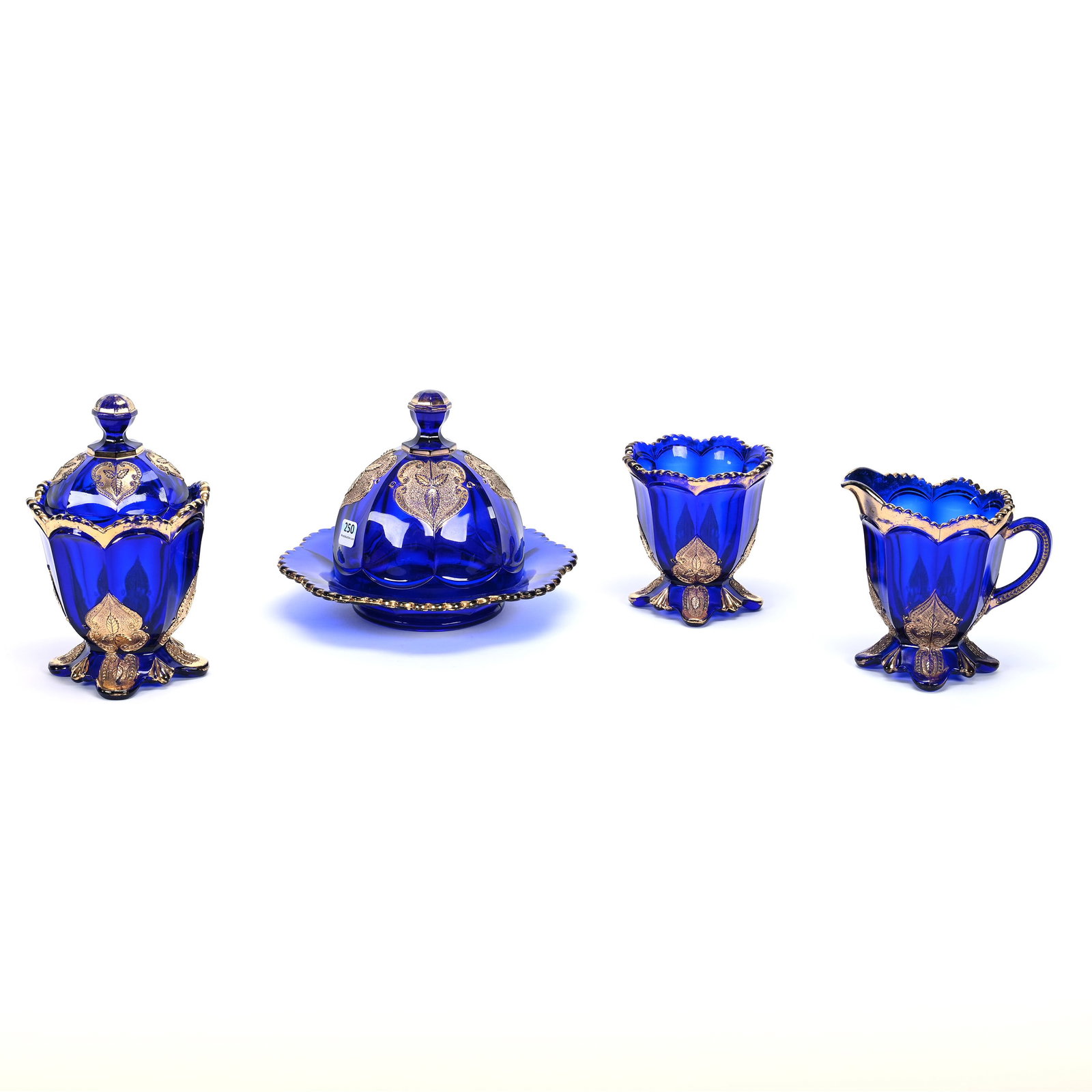 Table Set, Cobalt Blue Leaf Medallion Pattern Glass By Northwood: Table Set, Cobalt Blue Leaf Medallion Pattern Glass By Northwood, Butterdish, Creamer, Sugar And Spooner, Crack In Sugar Lid, Estate Of Marvin And Elfriede MIller, North Dakota.
