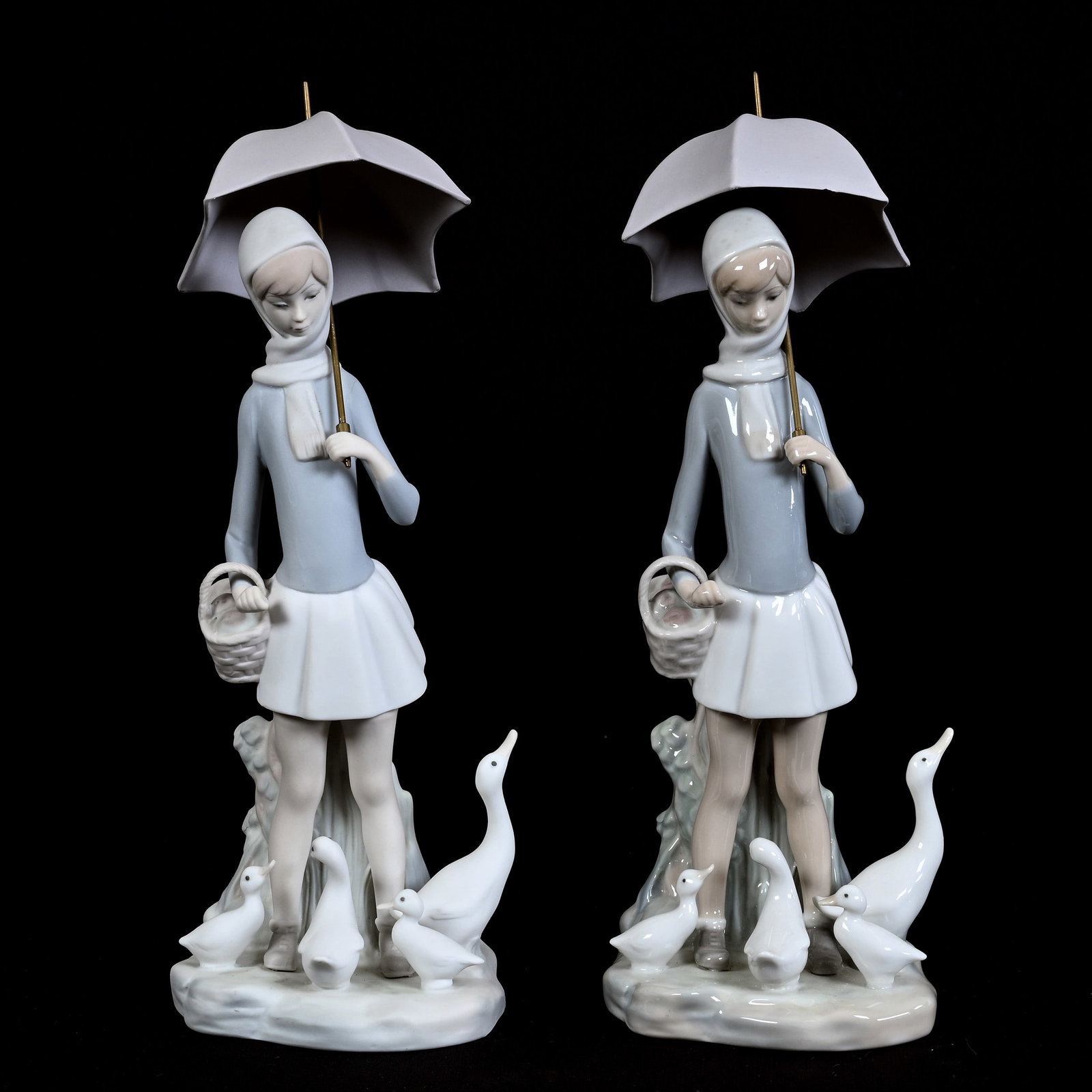 Matched Pair Of Figural Groups Marked Lladro Titled "Girl With Umbrella And Geese" #4510: Matched Pair Of Figural Groups Marked Lladro Titled "Girl With Umbrella And Geese" #4510, 10.5" x 4" Approximately, One With Matte Finish, One With Gloss Finish, Chipped Umbrella On Group With Gloss F