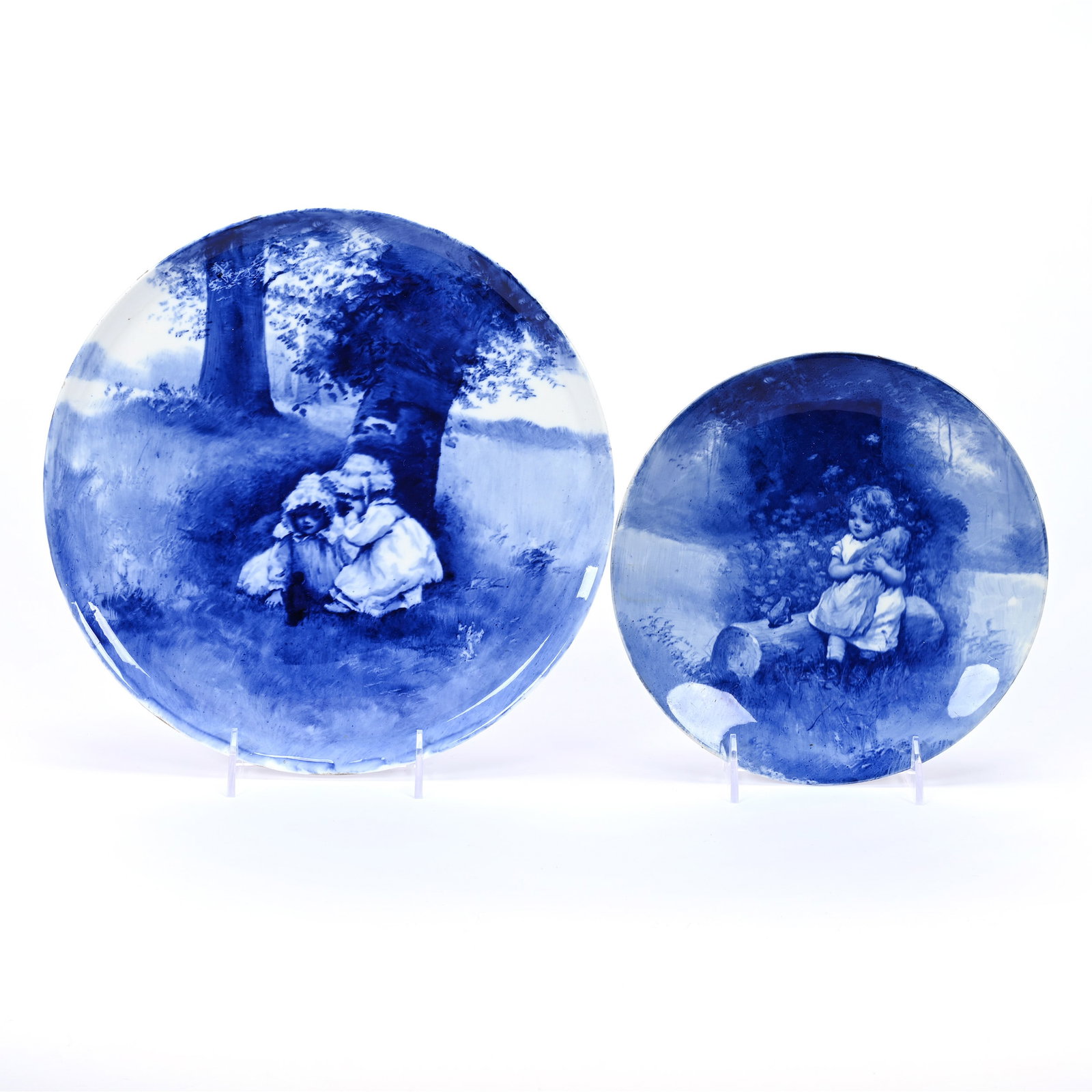 (2) Flow Blue Plates By Royal Doulton, Babes In Woods Scenic Decor: (2) Flow Blue Plates By Royal Doulton, Babes In Woods Scenic Decor, (1) 11.25" Round Serving Tray, Unmarked, Two Girls And Gnome (2) 8.75" Marked Royal Doulton, Young Girls Sitting On Log, Kansas Priv