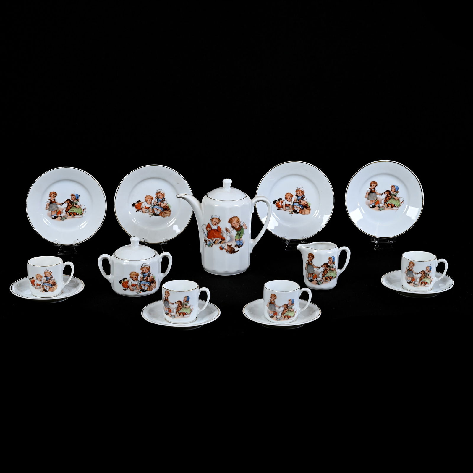 11 Piece Child's Tea Set, Marked Germany: 11 Piece Child's Tea Set, Marked Germany, White With Various Scenes Of Children At Play With Animals, (1) 6" x 6" Teapot, Creamer, Sugar, (4) 5.25" Plates, (4) Cups And Saucers, Large Plate With Rim C