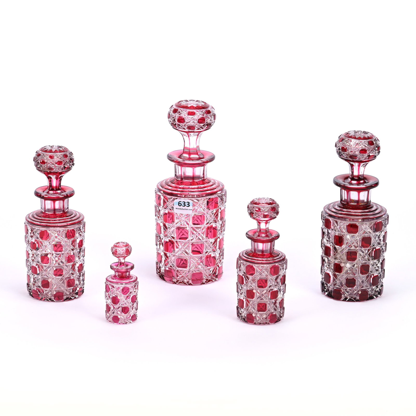 Vanity/Cologne Set, Five Piece, Brilliant Period Cut Glass, Cranberry Cut To Clear: Vanity/Cologne Set, Five Piece, Brilliant Period Cut Glass, Cranberry Cut To Clear, Cane Pattern With Pattern Cut Stoppers, Sizes Include 8.5", 7.75", 7"(Darker Color And One Hob On Stopper Is Chipped