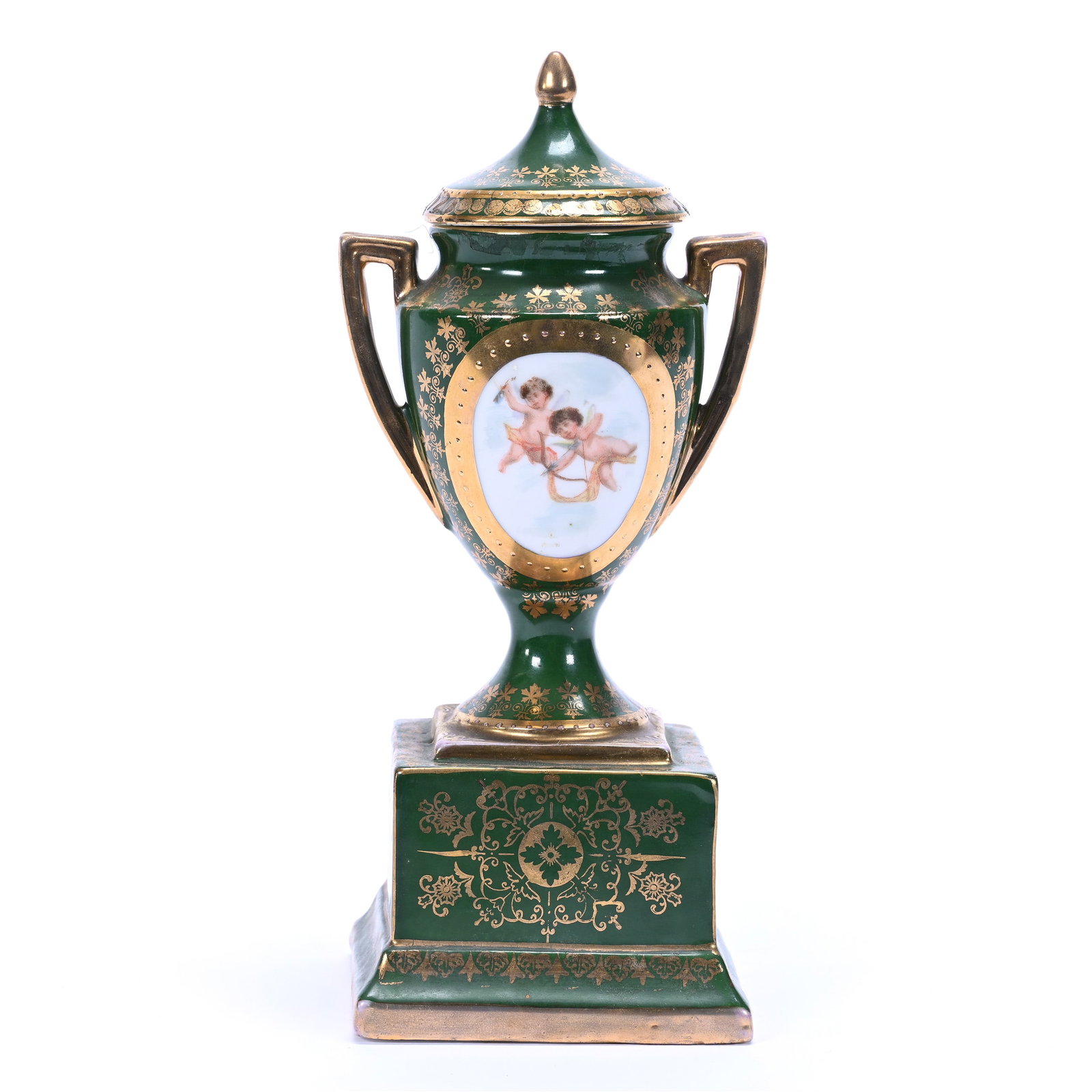 Pedestal Urn, Two Handles, Marked Victoria Karlsbad, Green Tones, Medallion Scene Of Cherubs: Pedestal Urn, Two Handles, Marked Victoria Karlsbad, Green Tones, Medallion Scene Of Cherubs, 8.5" x 3.75", Gold Stencil Highlights, Private Missouri Collection.
