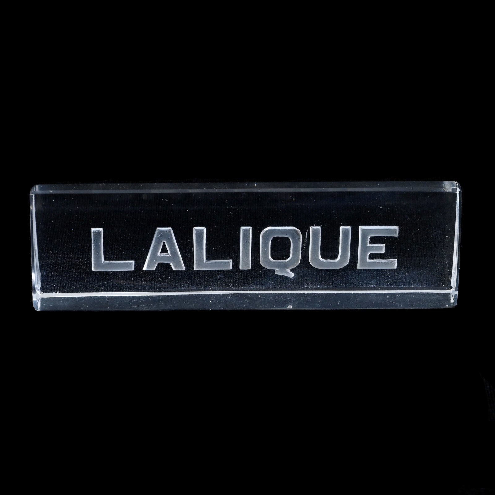 Counter Top Display Plaque, Marked "Lalique": Counter Top Display Plaque, Marked "Lalique", 1.25" x 4.25" x .5", Maurine and The Late Al Edmond Collection, IA.