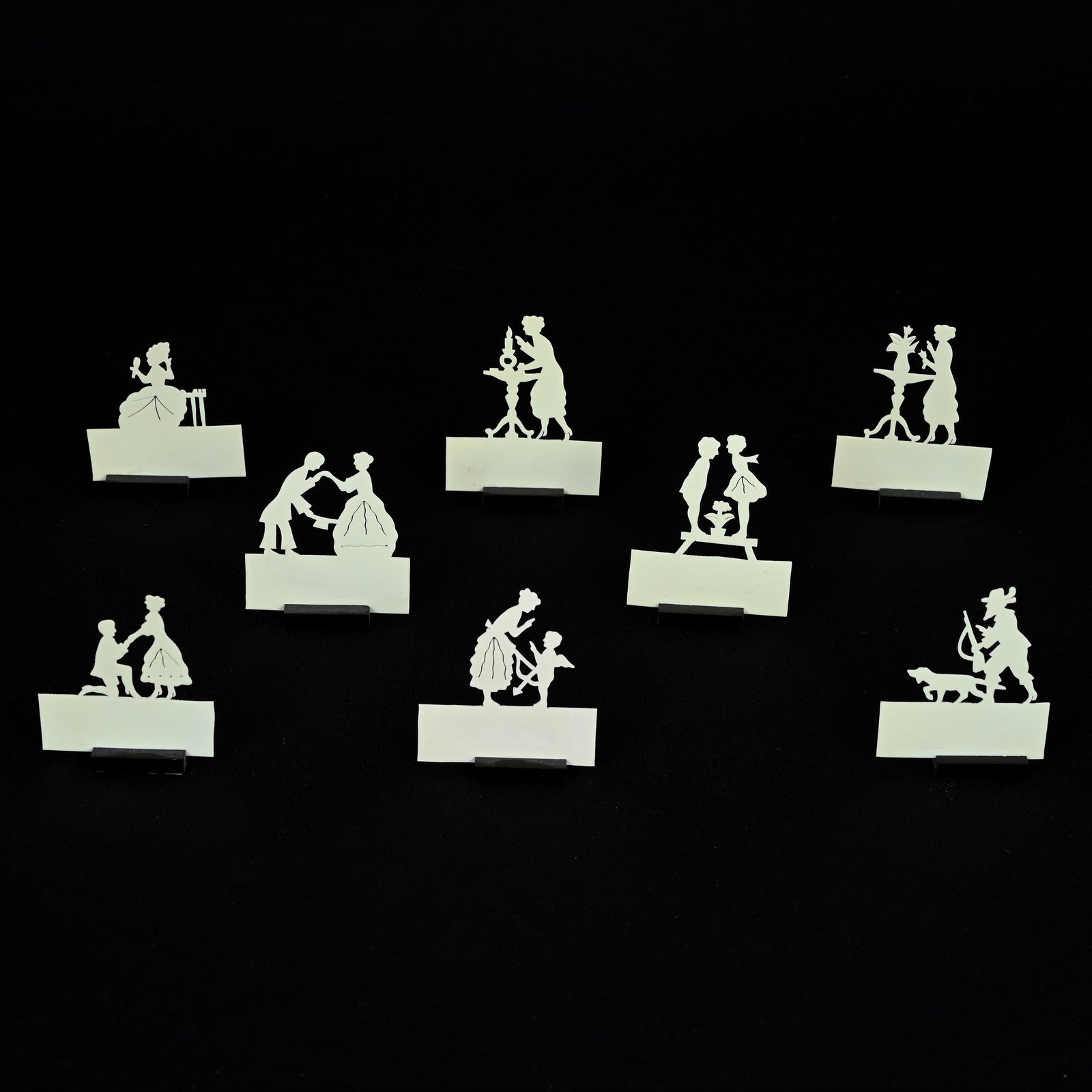 Eight Cut Out Silhouette Place Cards With Ebony Holders: Eight Cut Out Silhouette Place Cards With Ebony Holders, Approximately 2.25" x 2", Cutouts Are A Type Of Celluloid With Elaborate Silhouette Designs, Grady And Annette Hite Collection, NC.