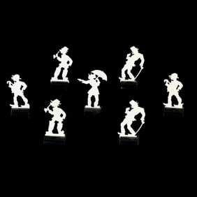 Seven Celluloid Cut Out Designs With Ebony Bases