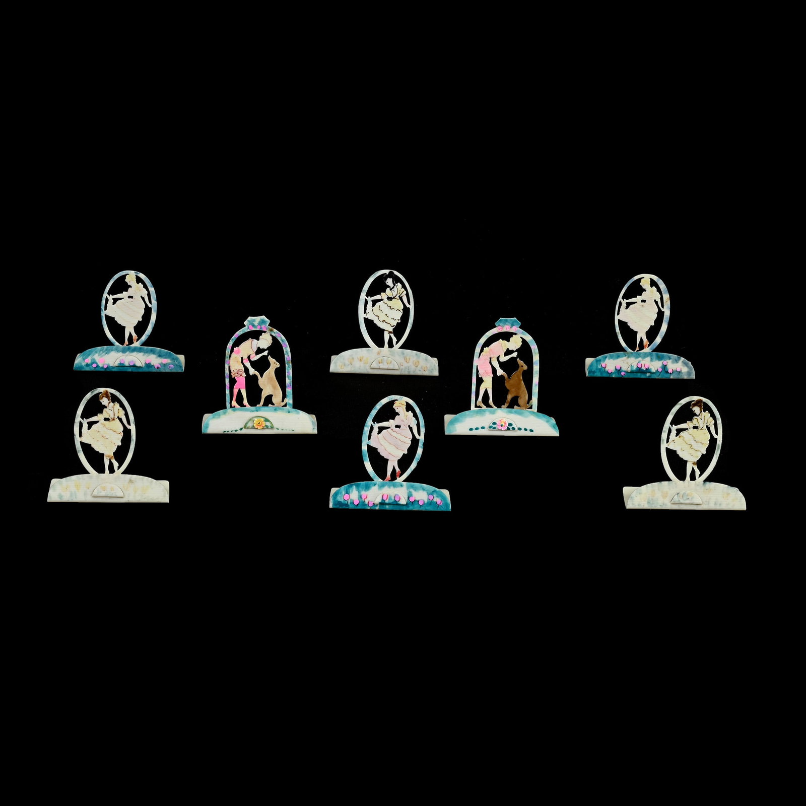 Eight Celluloid Cut Out Place Holders, Colored Highlights: Eight Celluloid Cut Out Place Holders, Colored Highlights, Approximately 2.25" x 2.25", (6) Feature Dancing Girl, (2) Feature Woman And Dog, Grady And Annette Hite Collection, NC.