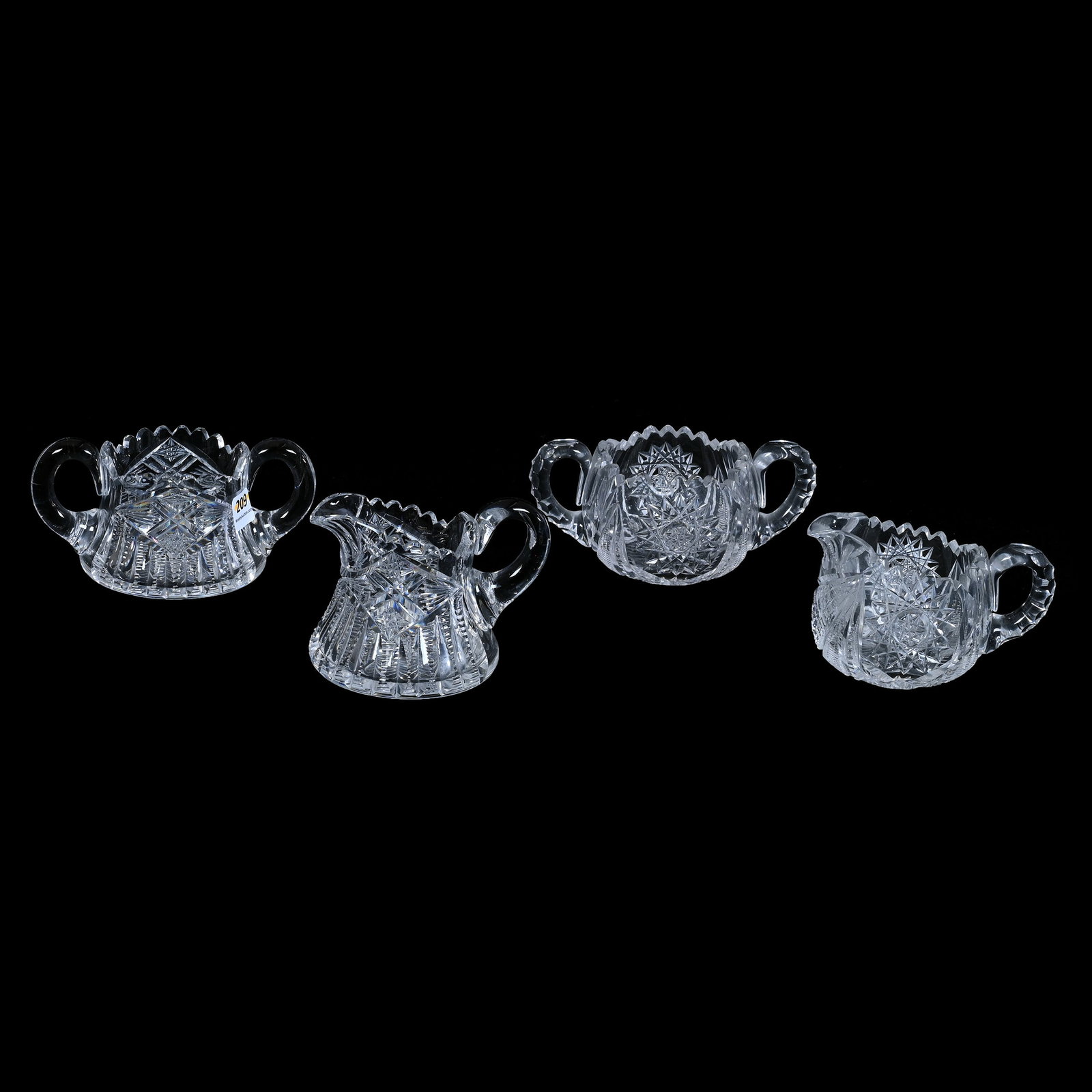(2) Creamer And Sugar Sets Including: (2) Creamer And Sugar Sets Including, (1) Set, Hobstar, Fan And Prism Motif, Uncut Handles, Ray Cut Base, (1) Set, Hobstar, Notched Fan, And Prism Motif, Ray Cut Base, Triple Notched Handles, Crack In