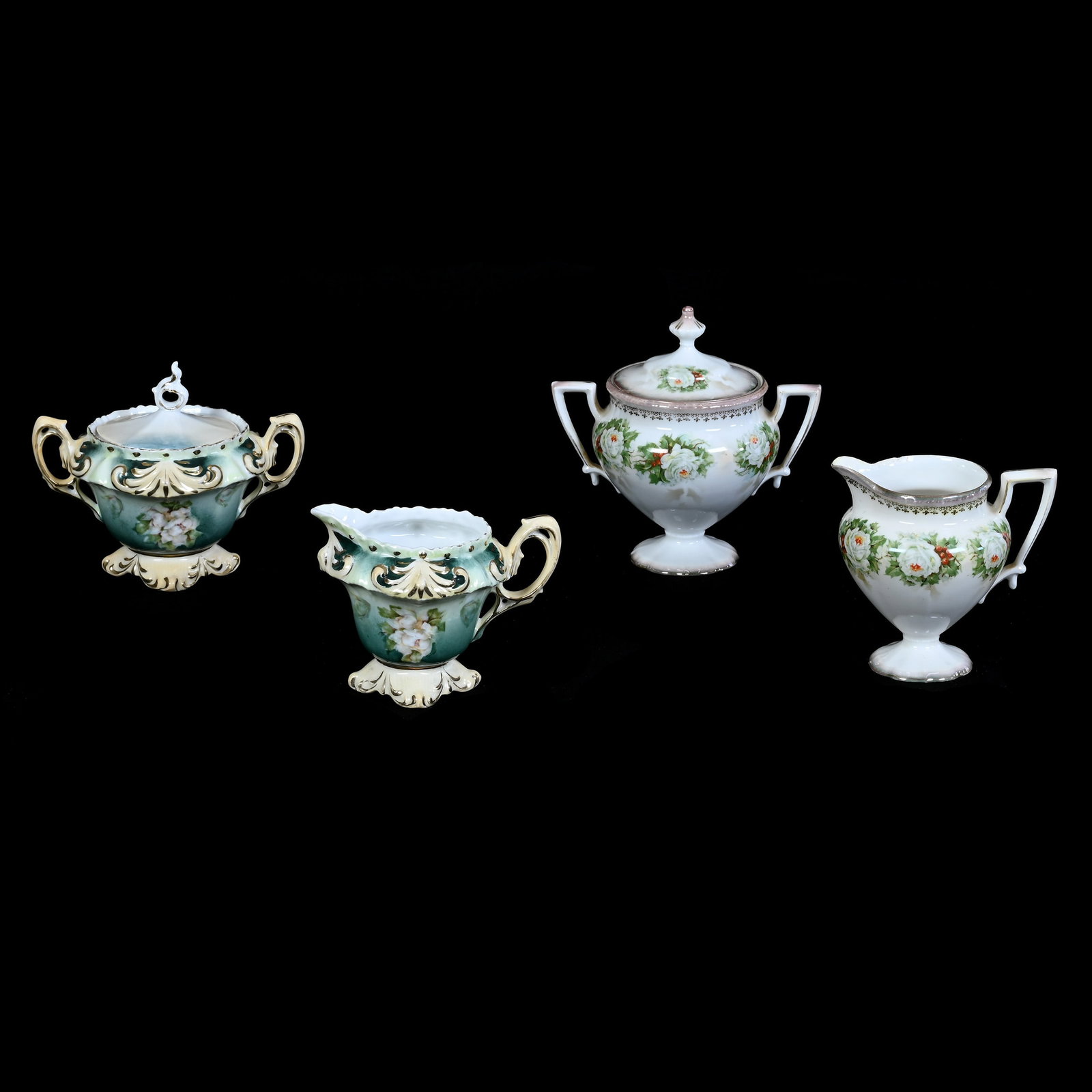 (2) Creamer and Sugar Sets Marked R.S. Prussia: (2) Creamer and Sugar Sets Marked R.S. Prussia, (1) 5.75" x 5.75" Pedestal, White and Lavender Luster Finish, White Rose Decor, Creamer With Interior Rim Chip, (1) 4.75" x 5.75" Fleur De Lys Mold, Mag
