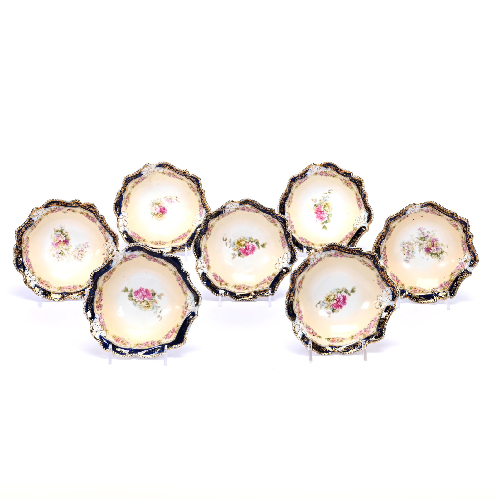 (7) Berry Dishes, Unmarked Prussia, Rose Decor, Cobalt Blue Border: (7) Berry Dishes, Unmarked Prussia, Rose Decor, Cobalt Blue Border, 5.5", Cream And White Center, Gold Stencil Highlights, One Bowl With Small Rim Nick, Neal and Barbara Smith Private Collection, Alab