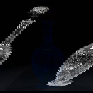 Footed Decanter, BPCG, Swirled Tusk With Engraved Floral And Leaf Design: Footed Decanter, Brilliant Period Cut Glass, Swirled Tusk With Engraved Floral And Leaf Design, 11" x 4.5", Ray Cut Foot, Elaborate Embossed Sterling Silver Stopper, Eleanor Eulau Collection.