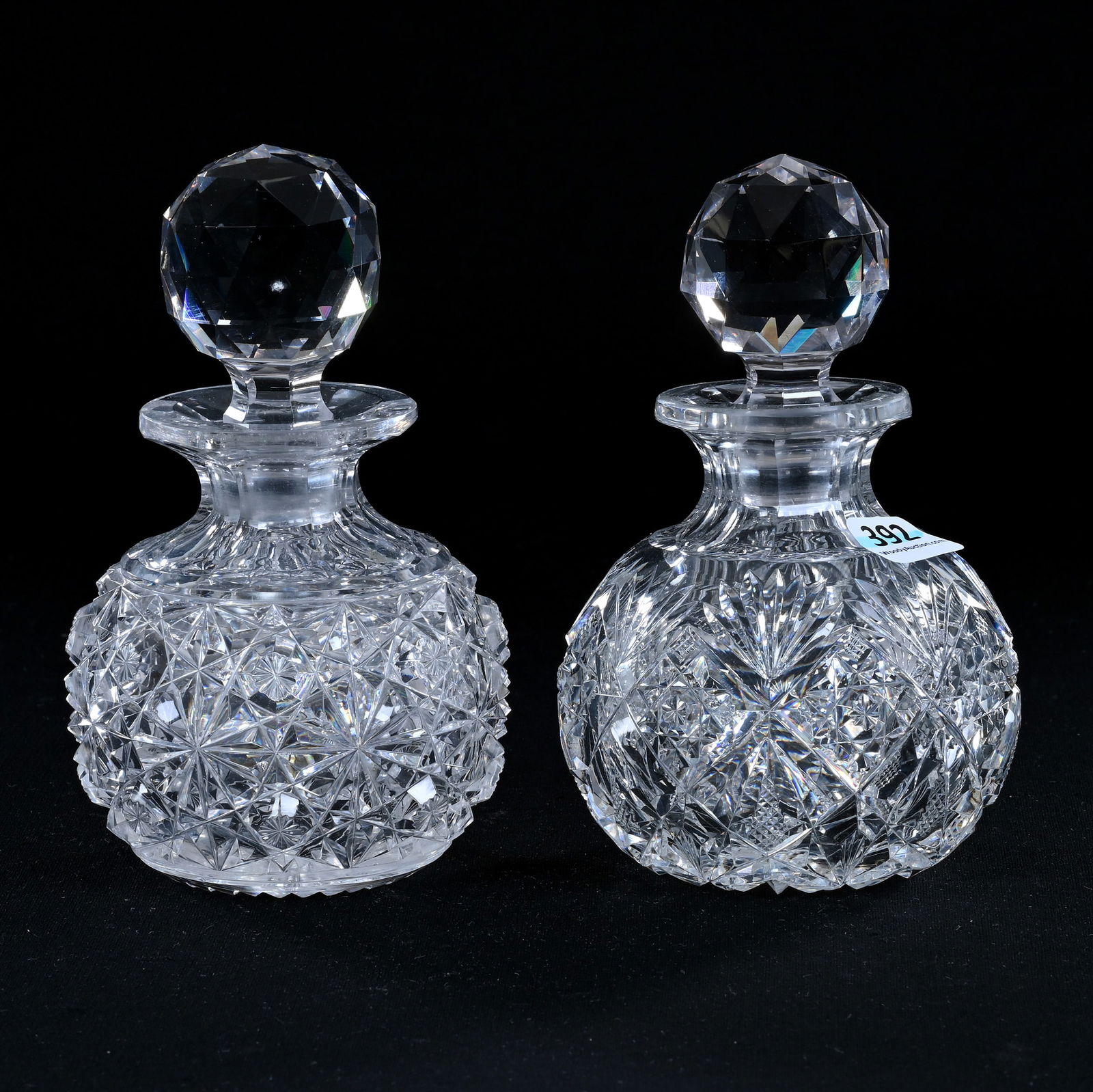 (2) Cologne Bottles, American Brilliant Cut Glass: (2) Cologne Bottles, American Brilliant Cut Glass, (1) 5.75" x 3.5", Russian Pattern, Star Cut Buttons, (1) 5.5" x 3.75", Marlboro Pattern By Dorflinger, Hobstar Base, One With Rim Roughness, Eleanor