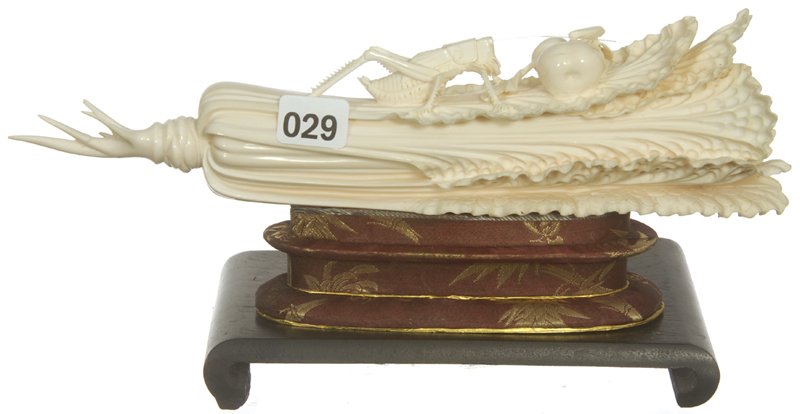 FANCIFUL 10" CARVED IVORY FIGURINE: FANCIFUL 10" CARVED IVORY FIGURINE CELERY STALK WITH FINELY DETAILED GRASSHOPPER AND FRUIT MOTIF - one root repaired - SET ON ORIGINAL STAND AND EBONY BASE - circa 1980's