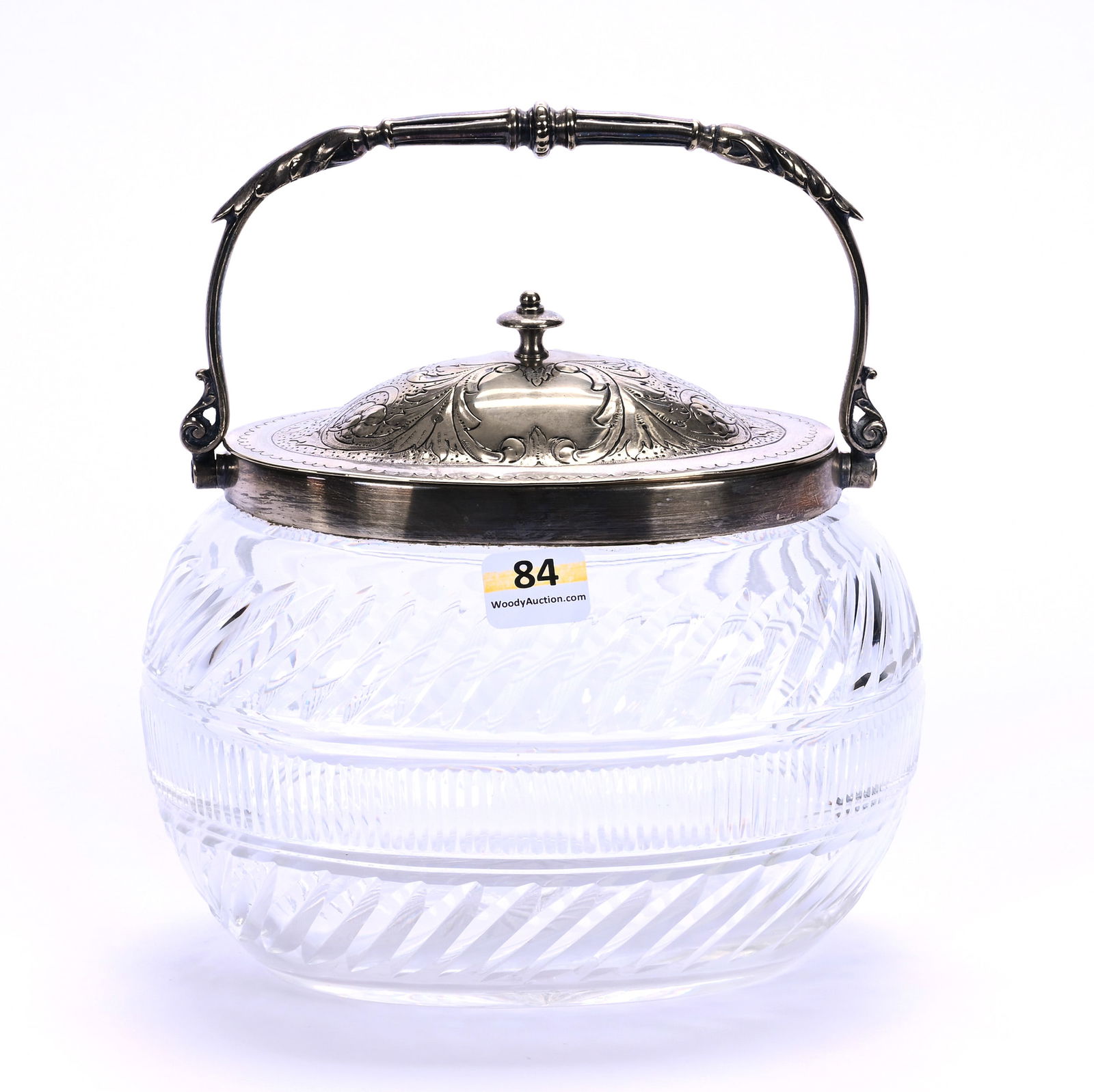 Oval Biscuit Jar, Brilliant Period Cut Glass: Oval Biscuit Jar, Brilliant Period Cut Glass, 6" x 6.75" x 5", Vertical And Slanted Miter Motif, Silverplate Lid And Bail, Raycut Base, Georgia Private Collection.