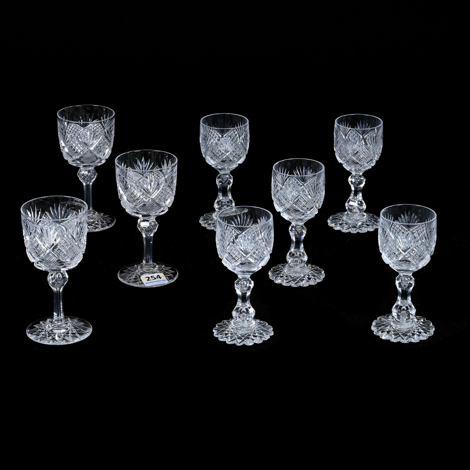 (8) Wine Stems, American Brilliant Cut Glass, Crosscut Diamond, Crosshatch And Fan Motif: (8) Wine Stems, American Brilliant Cut Glass, Crosscut Diamond, Crosshatch And Fan Motif, All Same Pattern, (3) 4.5" With Round Hobstar Foot, (5) 4.25" With Double Teardrop Stem, Scalloped Hobstar Foo
