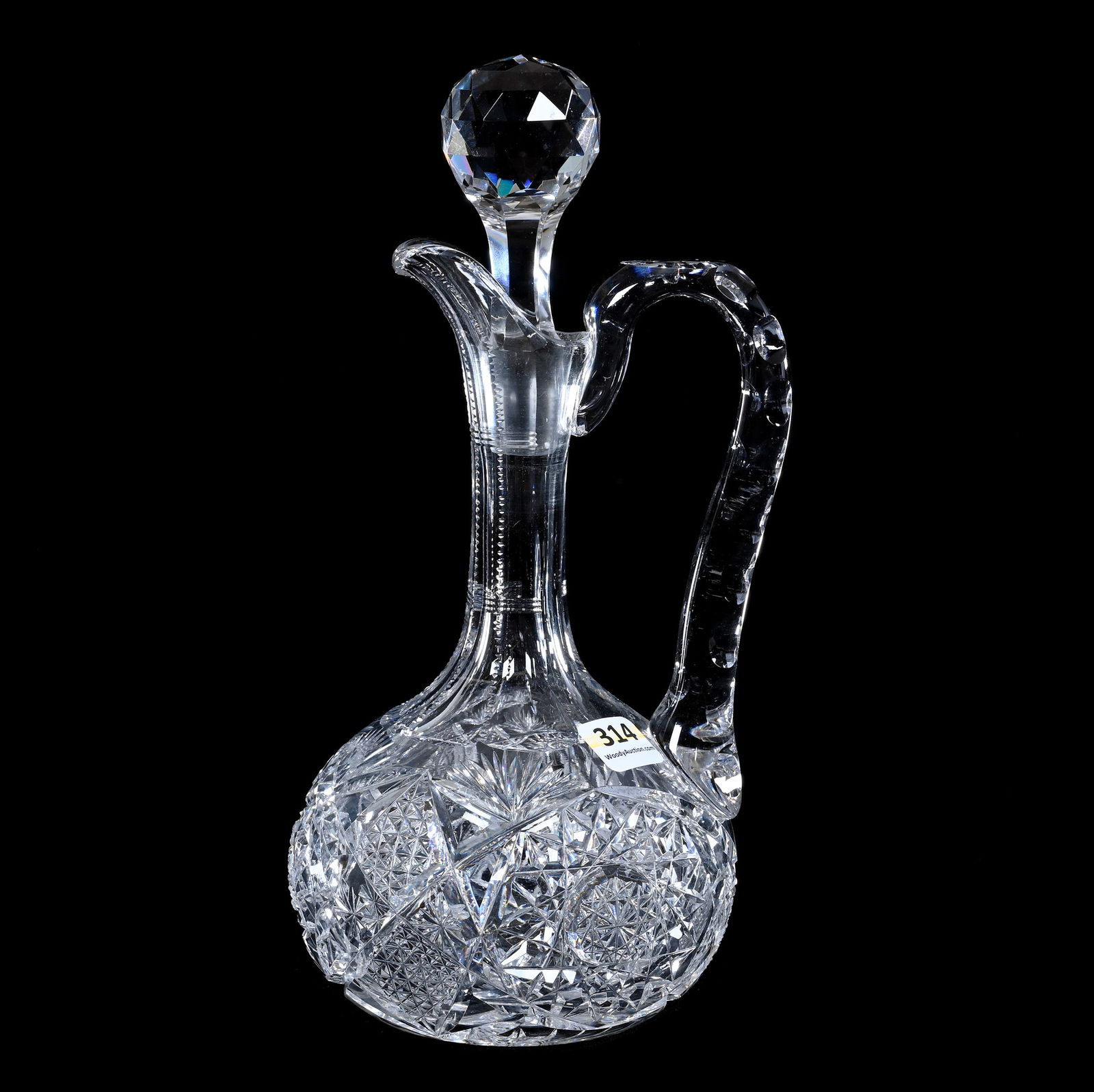 Decanter, Handled, American Brilliant Cut Glass, Hobstar, Quartered Diamond, Star And Fan Motif: Decanter, Handled, American Brilliant Cut Glass, Hobstar, Quartered Diamond, Star And Fan Motif, 10" x 4.75", Double Notched Handle, Ray Cut Base, Sherri Schott Collection, Kansas.