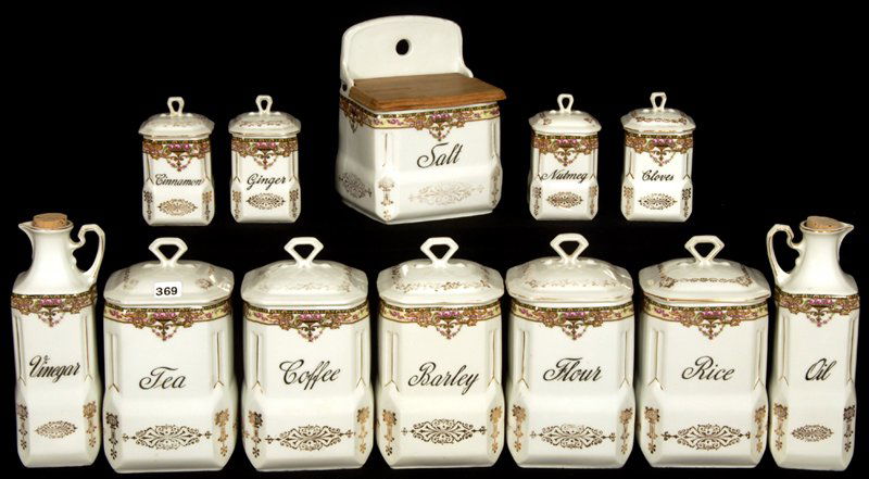 TWELVE PIECE CZECHOSLOVAKIA PORCELAIN CANISTER SET: TWELVE PIECE CZECHOSLOVAKIA PORCELAIN CANISTER SET WHITE WITH FLORAL BORDER AND GOLD STENCIL HIGHLIGHTS - SALT, CLOVES, NUTMEG, CINNAMON, GINGER, FLOUR, RICE, BARLEY, TEA, COFFEE, OIL AND VINEGAR - NI