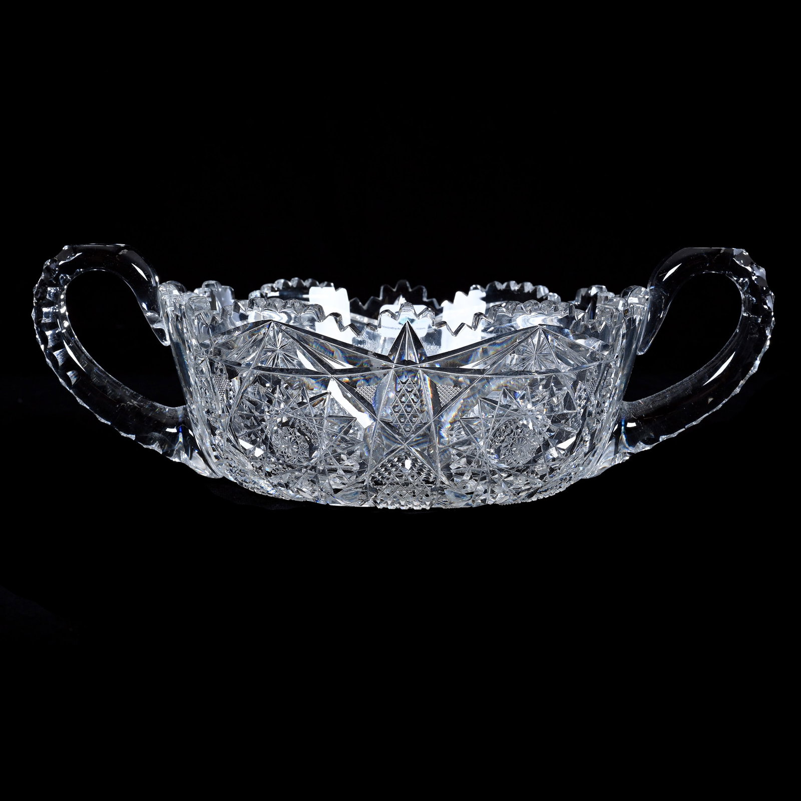 Two Handled Bowl, American Brilliant Cut Glass, Hobstar And Nailhead Diamond Motif: Two Handled Bowl, American Brilliant Cut Glass, Hobstar And Nailhead Diamond Motif, 4" x 12.25" x 8", 3.64 Pounds, Triple Notched Handles, One Handle With Crack, The Bob Lawroski Estate.