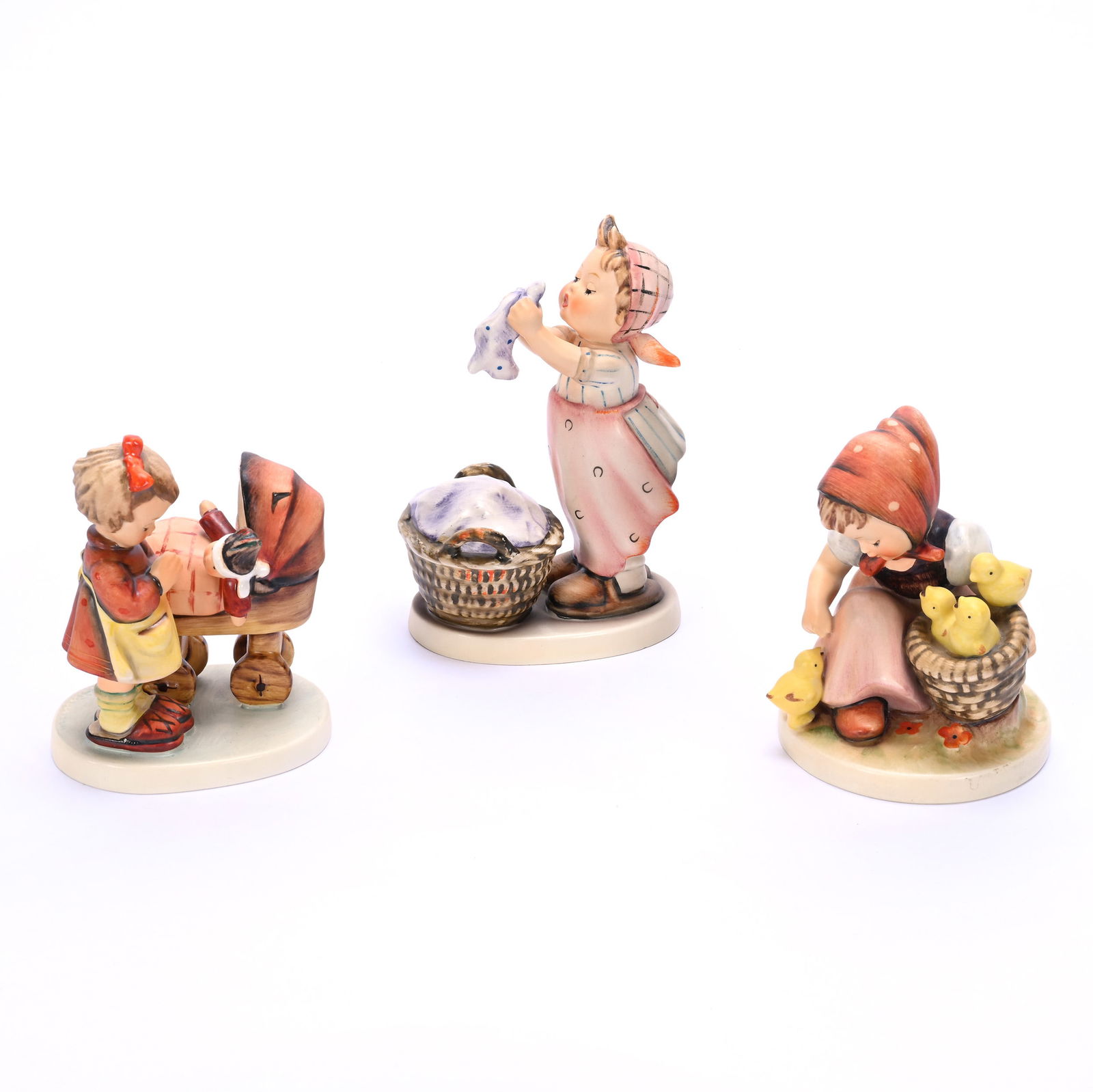 (3) Hummel Figurines: (3) Hummel Figurines, 1.52 Pounds, (1) 4.5" x 3.5" x 3.5", Chick Girl #57/1, TM-3, (1) 5.75" x 4" x 2.5", Wash Day #321, TM-4, (1) 4.5" x 3.5" x 2.5", Doll Mother #67, TM-5, Bill And Kathleen Pratt Co