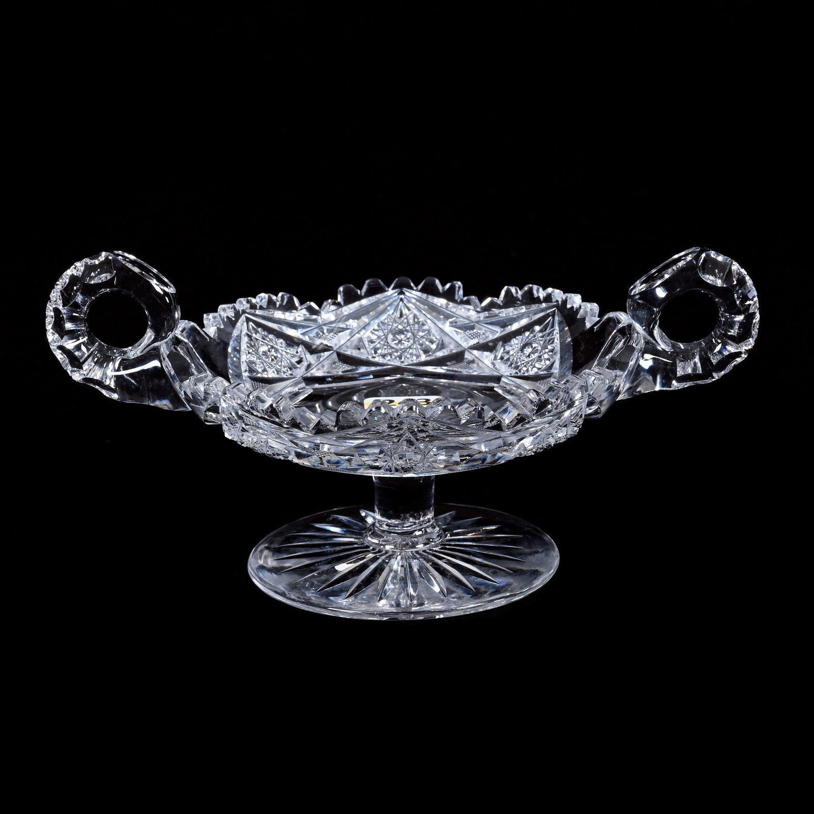 Pedestal Two Handled Bon Bon, American Brilliant Cut Glass: Pedestal Two Handled Bon Bon, American Brilliant Cut Glass, 3.75 x 7.5 x 5 Inches, Hobstar, Crosscutting, And Miter Motif, Double Notched Handle, Ray Cut Foot, 2 Pounds, Colorado Private Collection.
