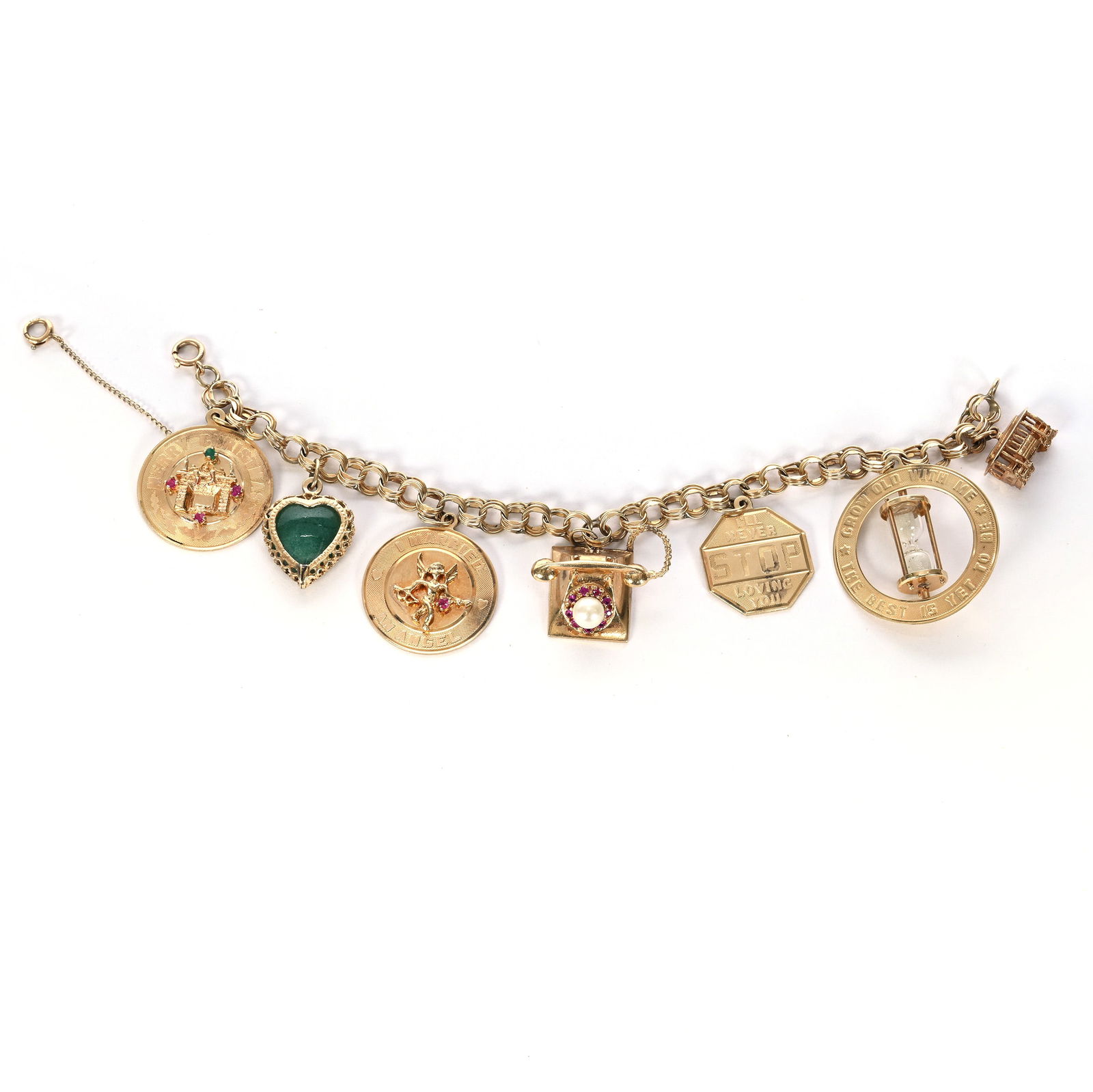 14k Gold Charm Bracelet With (7) Charms Including:: 14k Gold Charm Bracelet With (7) Charms Including: 7 x 0.5 x 1.25 Inches, Hourglass, Trolley, Stop Sign, Telephone, Heart With Jade Stone, Two Medallions, 32.0 Grams, Dr. Harold & Audrey Eklund Estate