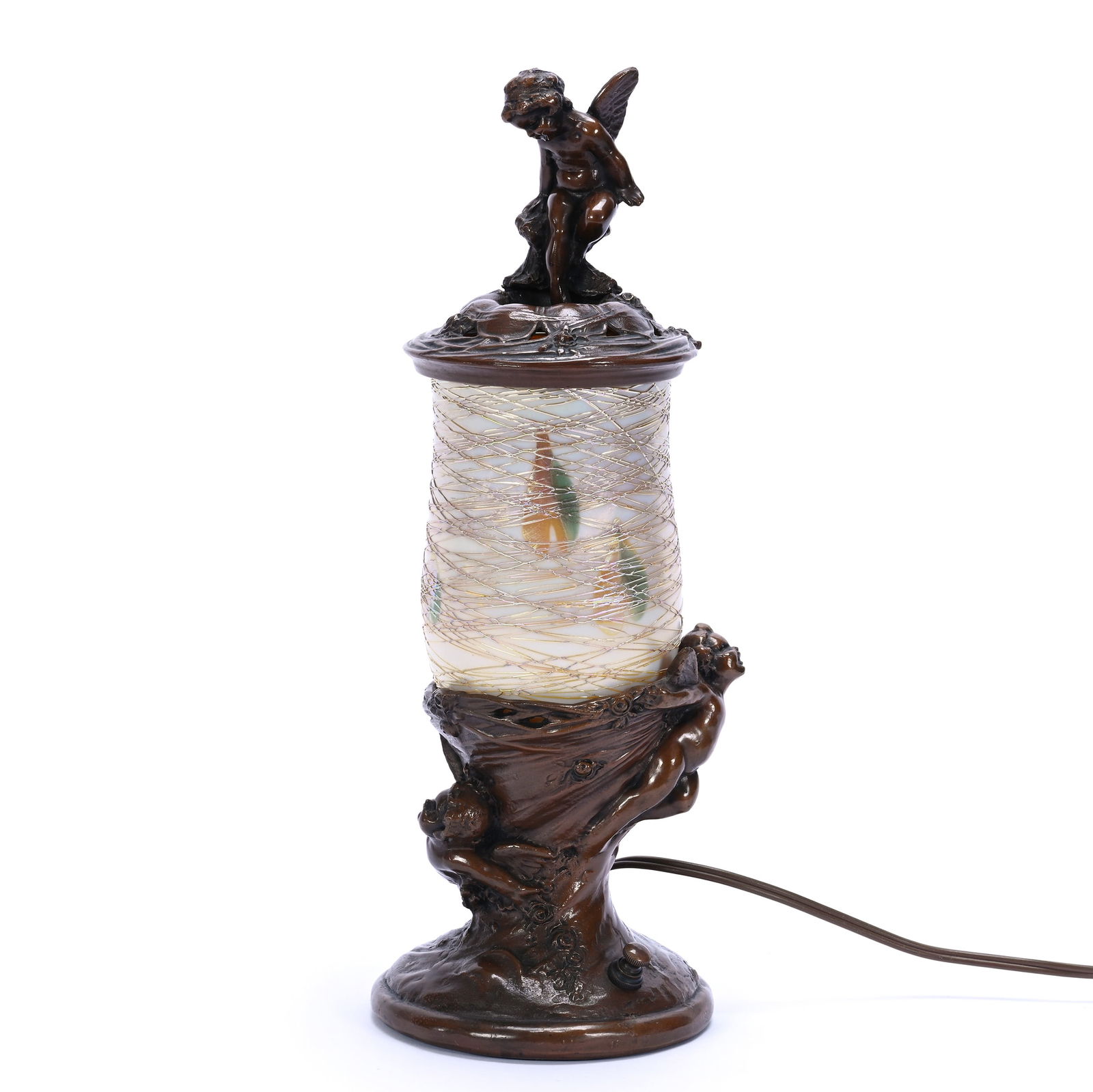 Desk Lamp, Figural Bronze Base Featuring Cherubs With Removable Bronze Cap With Cherub: Desk Lamp, Figural Bronze Base Featuring Cherubs With Removable Bronze Cap With Cherub, 13.5 x 4.75 x 4.75 Inches, Signed Lustre Art Shade Is Iridescent White Art Glass With Green And Gold Heart And