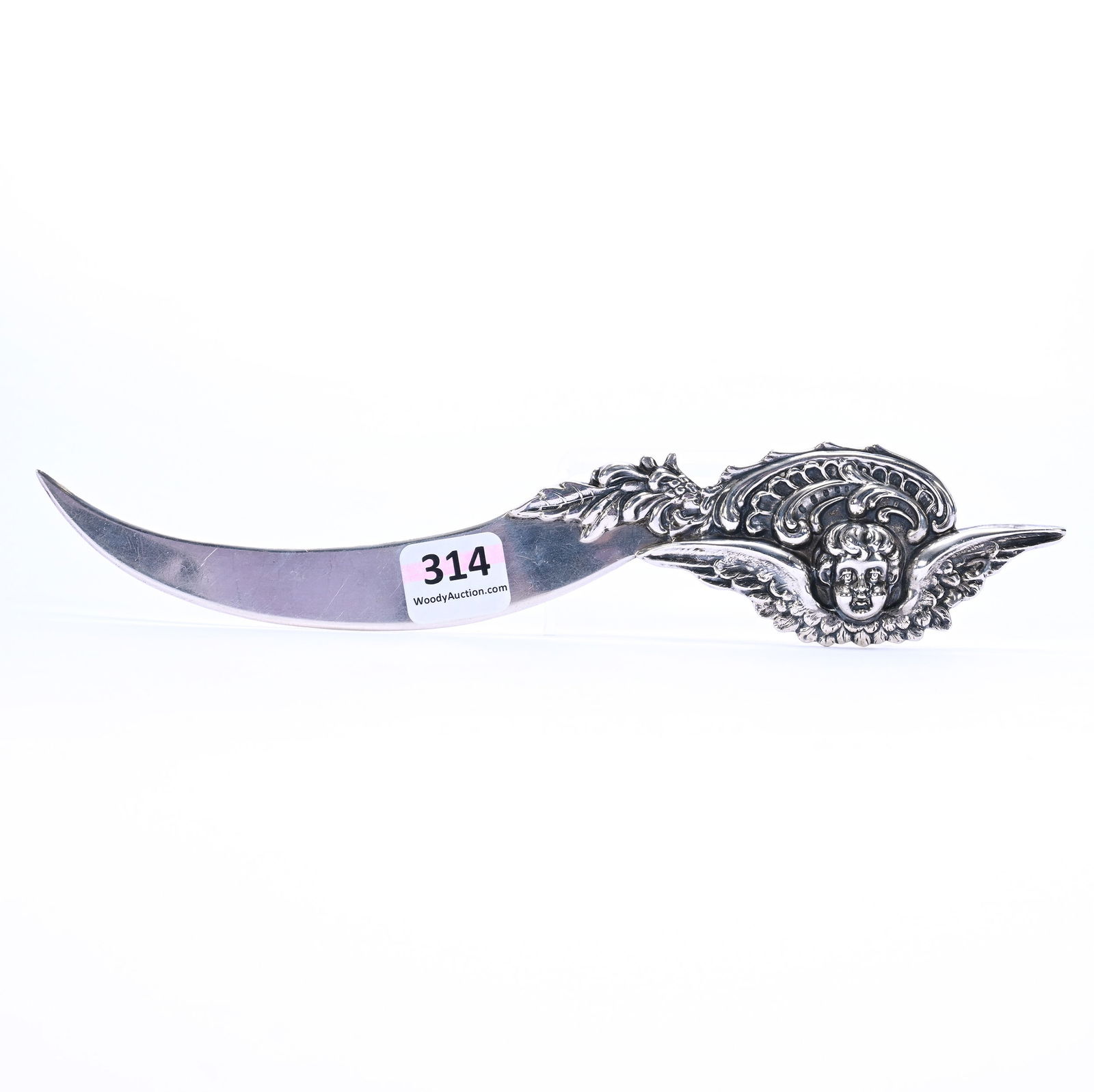 Solid Sterling Silver Letter Opener Marked Kerr & Company: Solid Sterling Silver Letter Opener Marked Kerr & Company, 8.75 x 1.75 x 0.25 Inches, Embossed Winged Cherub & Scroll Design Handle, Curved Blade, 61.0 Grams, Dr. Harold & Audrey Eklund Estate, Iowa.