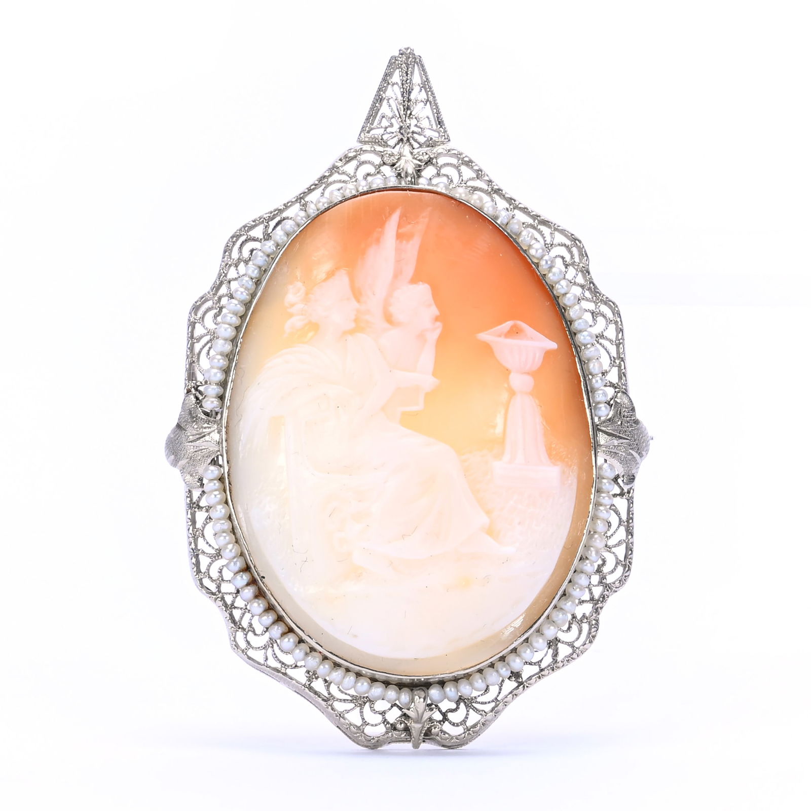 14k White Gold And Vintage Carved Cameo Broach: 14k White Gold And Vintage Carved Cameo Broach, 2.25 x 2.5 x 0.625 Inches, Scene Of Seated Woman & Angel, Filigree Frame, Seed Pearl Highlights, 12.0 Grams, Dr. Harold & Audrey Eklund Estate, Iowa.