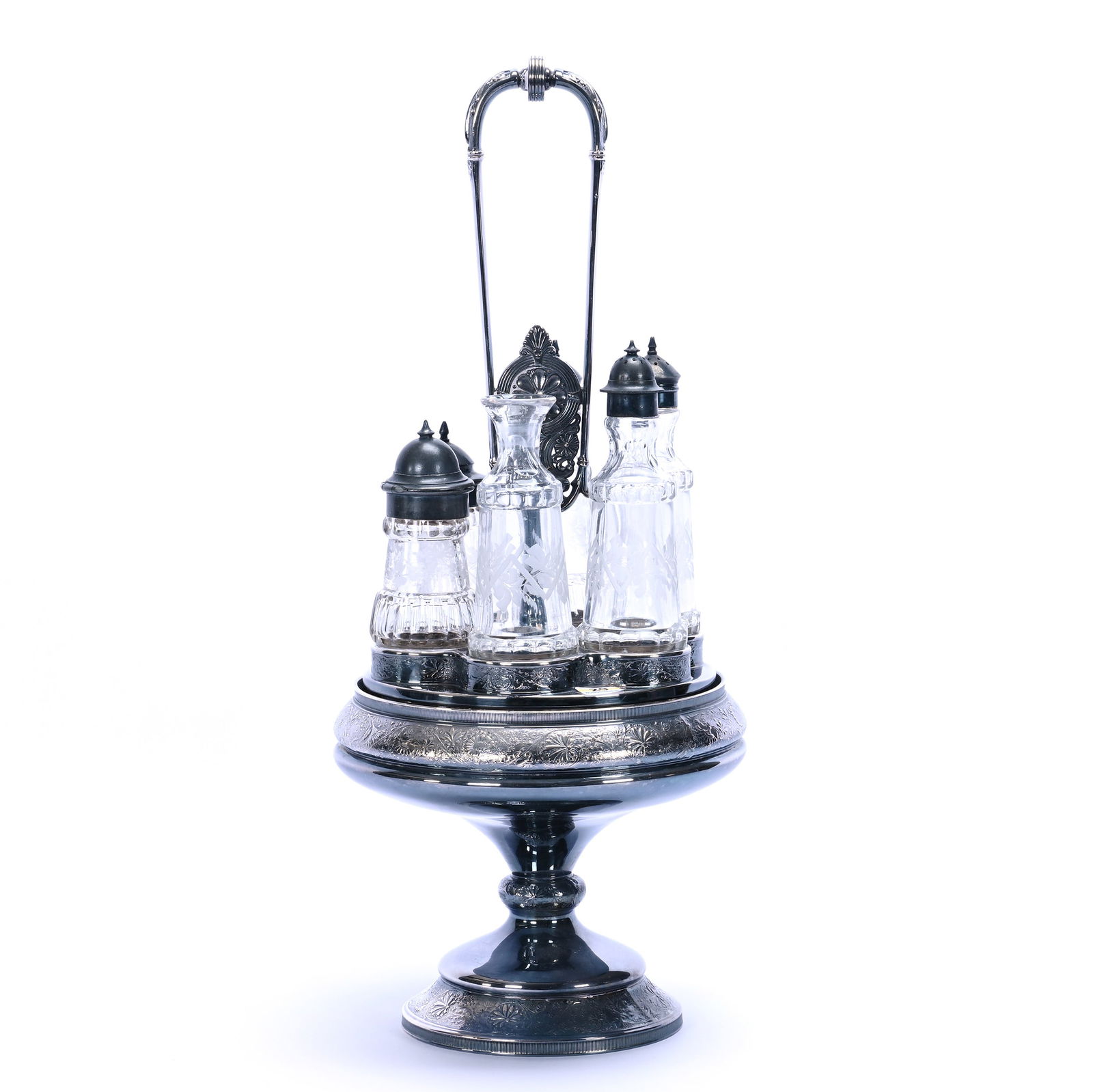 Castor Set: Castor Set, 19.25 x 8.5 x 8.5 Inches, (6) Clear Pattern Glass Inserts With Engraved Floral Highlights, Set On Mermod Jaccard & Co #250 Silverplate Revolving Stand, One Cruet Bottle Missing Stopper,